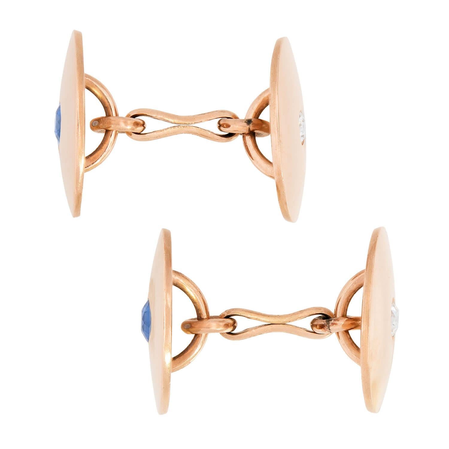 An attractive and unusual pair of cufflinks from the Victorian (ca880) era! These double-sided cufflinks are crafted in 14k and circular in shape. Two of the faces feature a bezel set sapphire, which display a lovely cornflower blue hue and have an