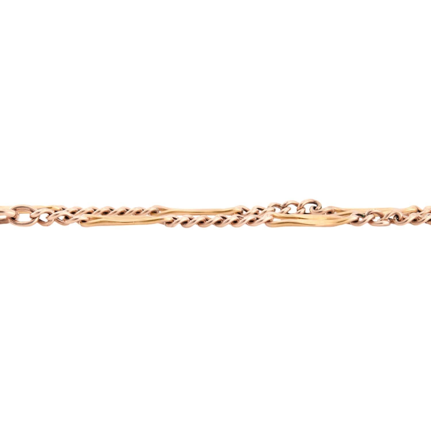 A fabulous watch chain necklace from the Victorian (ca1880s) era! Crafted in 14k yellow gold, this necklace features a unique chain, which incorporates 12 ellipse shaped links with a central cutout. The remainder of the necklace is curb chain. Both