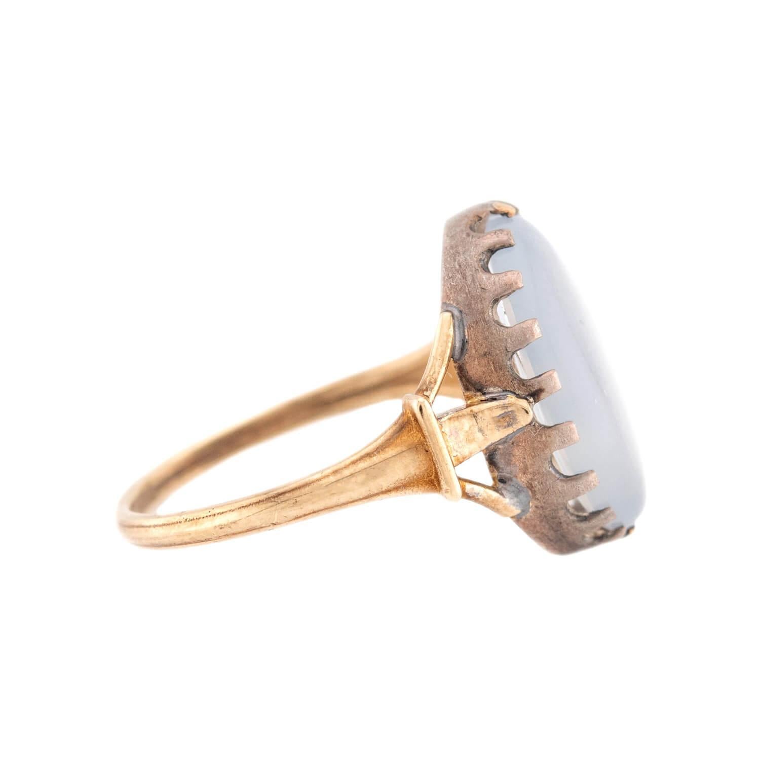 A beautiful moonstone ring from the Victorian (ca1880) era! This lovely ring is made of 14kt yellow gold holds a moonstone cabochon at its center in a sterling silver mounting. The elongated moonstone is oval in shape and has a wonderful pearly