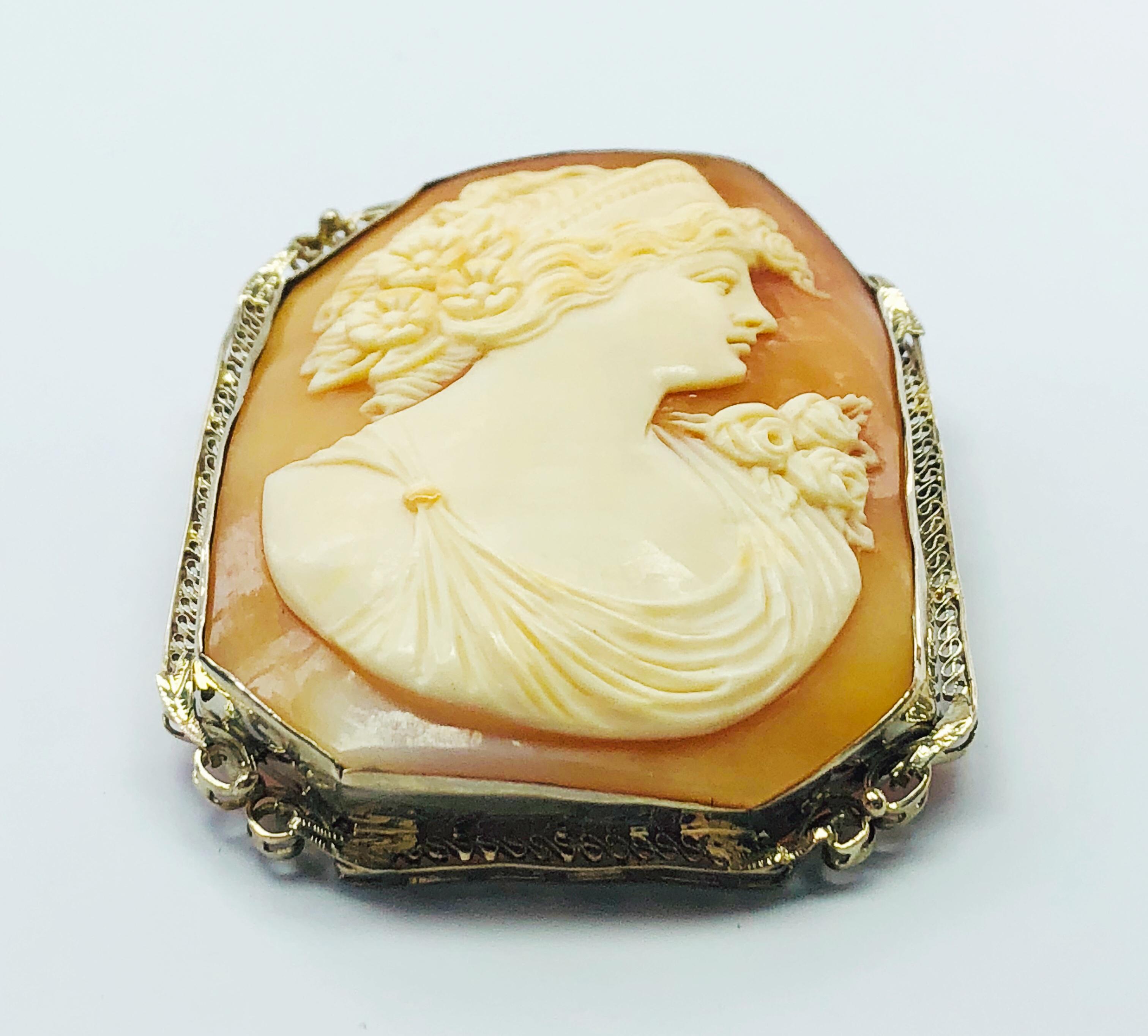 This is a RARE, Victorian, Hand carved, Estate 14K Yellow Gold and Shell Cameo! This gorgeous Cameo is very unique as it is fusion shaped sed in a fantastic filigree bezel. The listed measurements do not include the bale.
This Piece is from a large