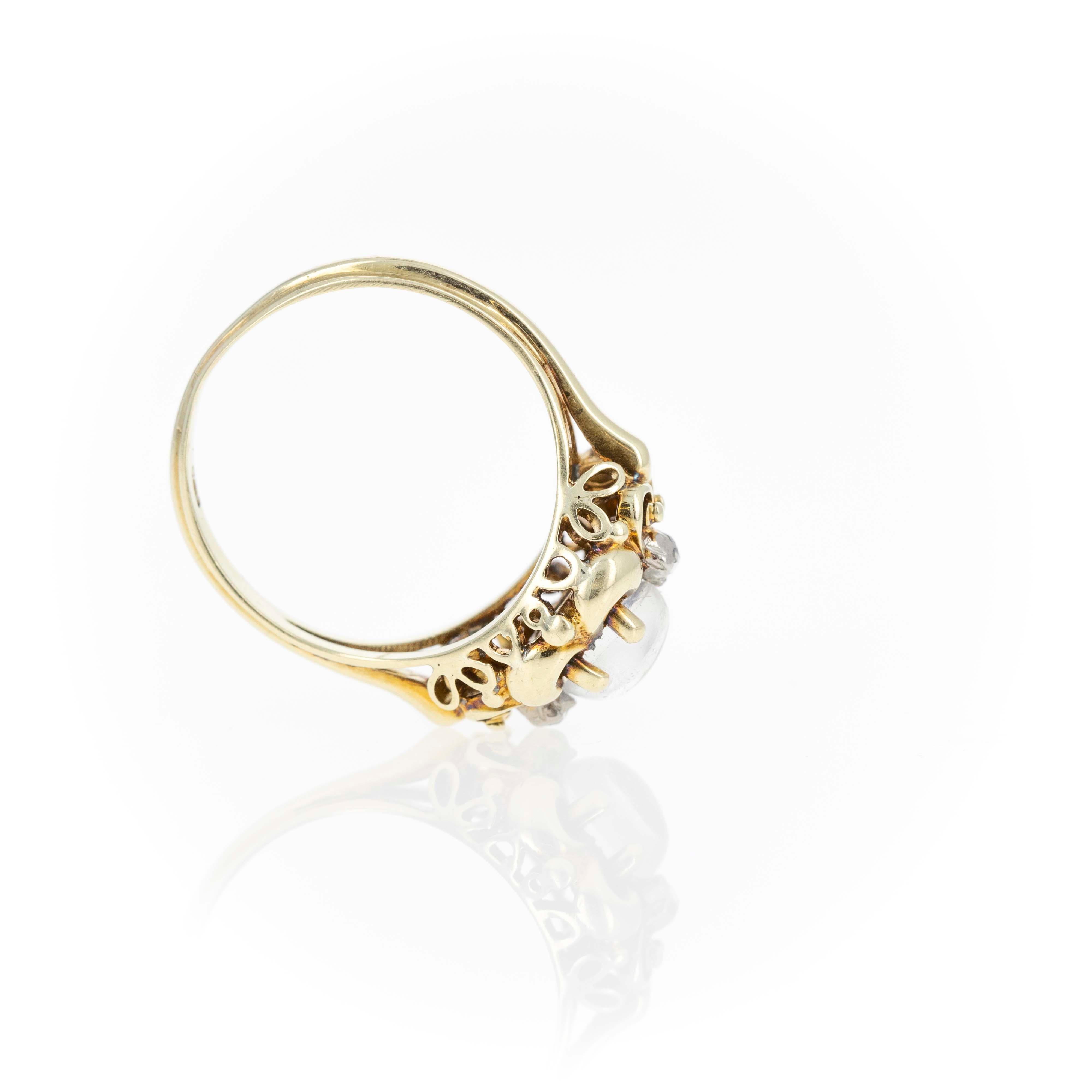 Era: Victorian Estate
Composition: 14K Yellow Gold
Primary Stone: Round Cabochon Natural Moonstone
Carat Weight: Approximately 1 Carat
Accent Stone: Two Rose Cut Diamonds
Carat Weight: Approximately 0.03 Carats in Total
Color/Clarity: H-I /