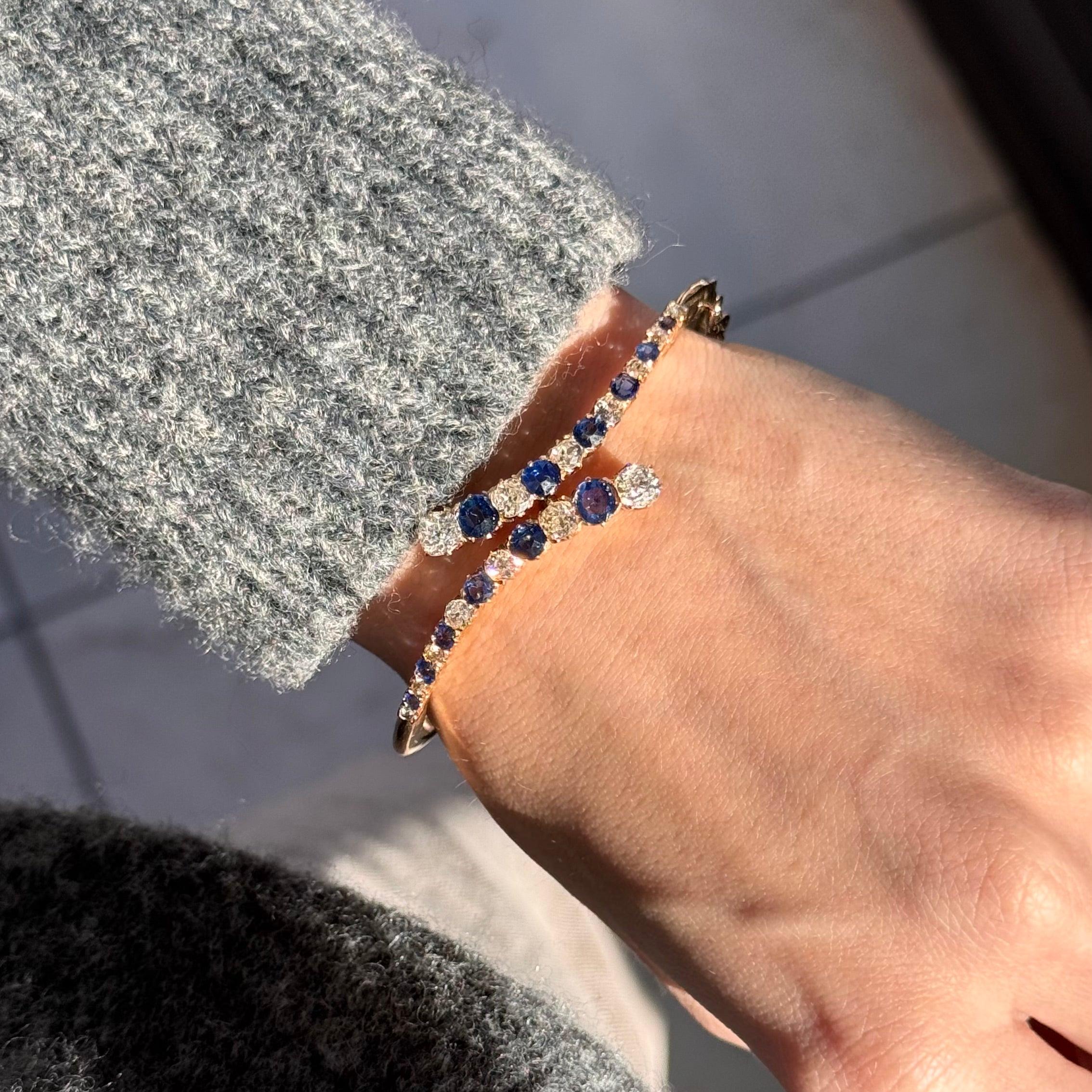 Era: Victorian

Composition: 14K Yellow Gold

Primary Stone: Twelve Natural Sapphires

Carat Weight: Approximately 2 Carats Total

Accent Stone: Old European Cut and Old Mine Cut Diamonds

Carat Weight: Approximately 2.5 Carats Total

Color/Clarity: