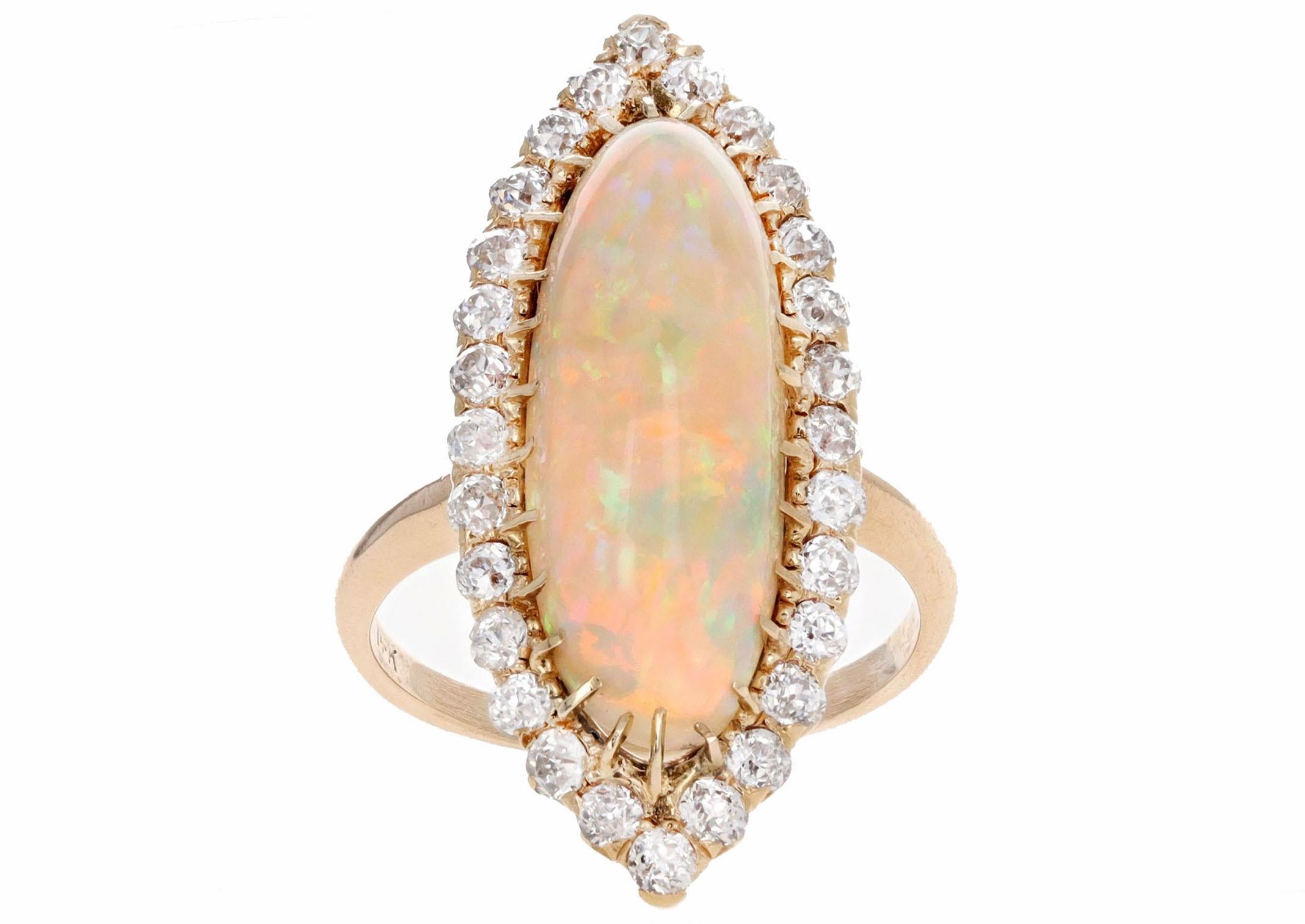 Era: Victorian Estate

Composition: 14K Yellow Gold

Primary Stone: Oval Cabochon Cut Ethiopian Opal

Carat Weight: Approximately 5 Carats

Accent Stone: Twenty Eight Old European Cut Diamonds

Carat Weight: Approximately 0.56 Carats in