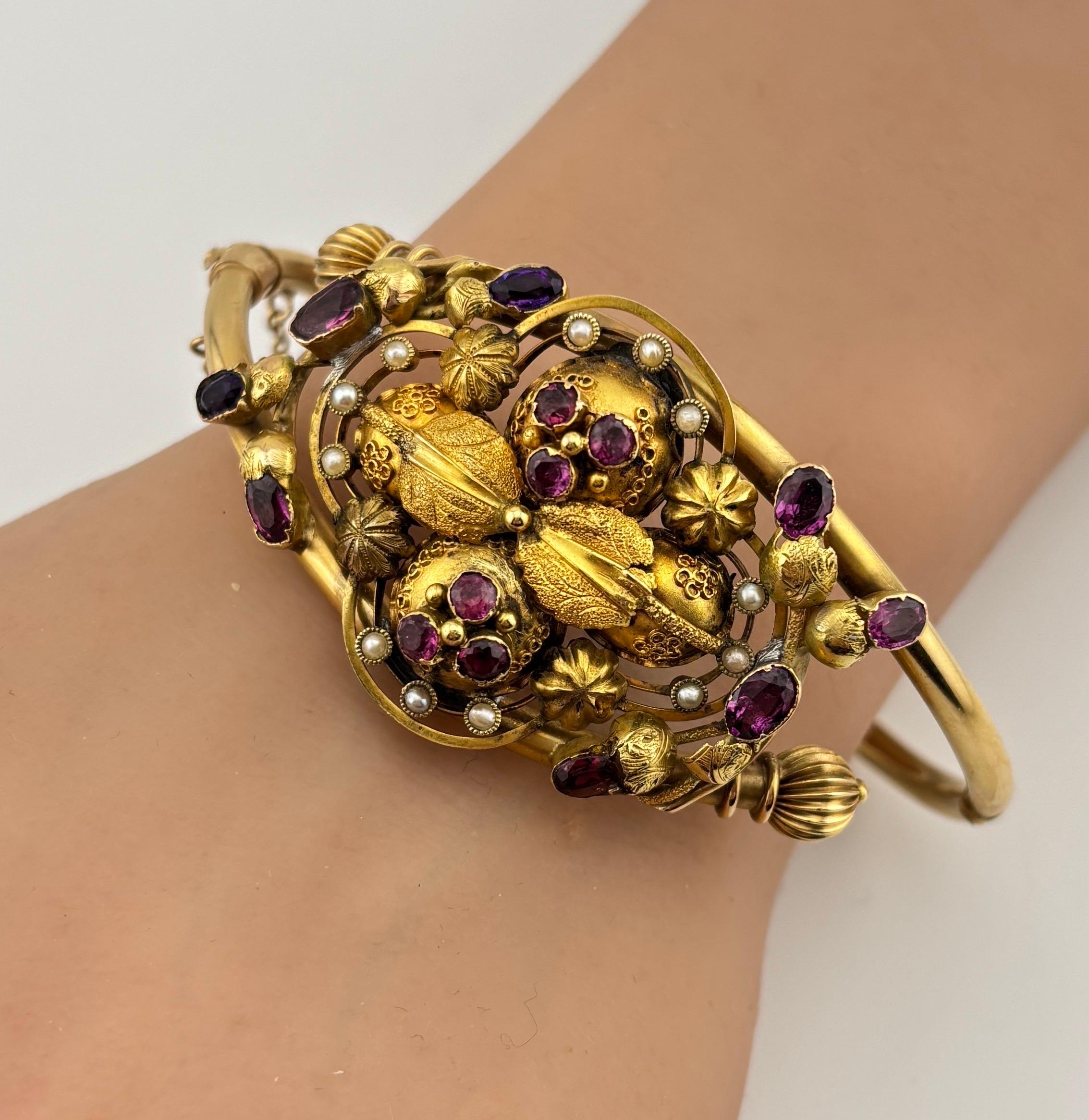This Victorian 14k gold amethyst and garnet bracelet is a stunning blend of rich colors and vintage craftsmanship. The Victorian era was known for its ornate jewelry, often with intricate designs and deep, meaningful gemstones. The bracelet features