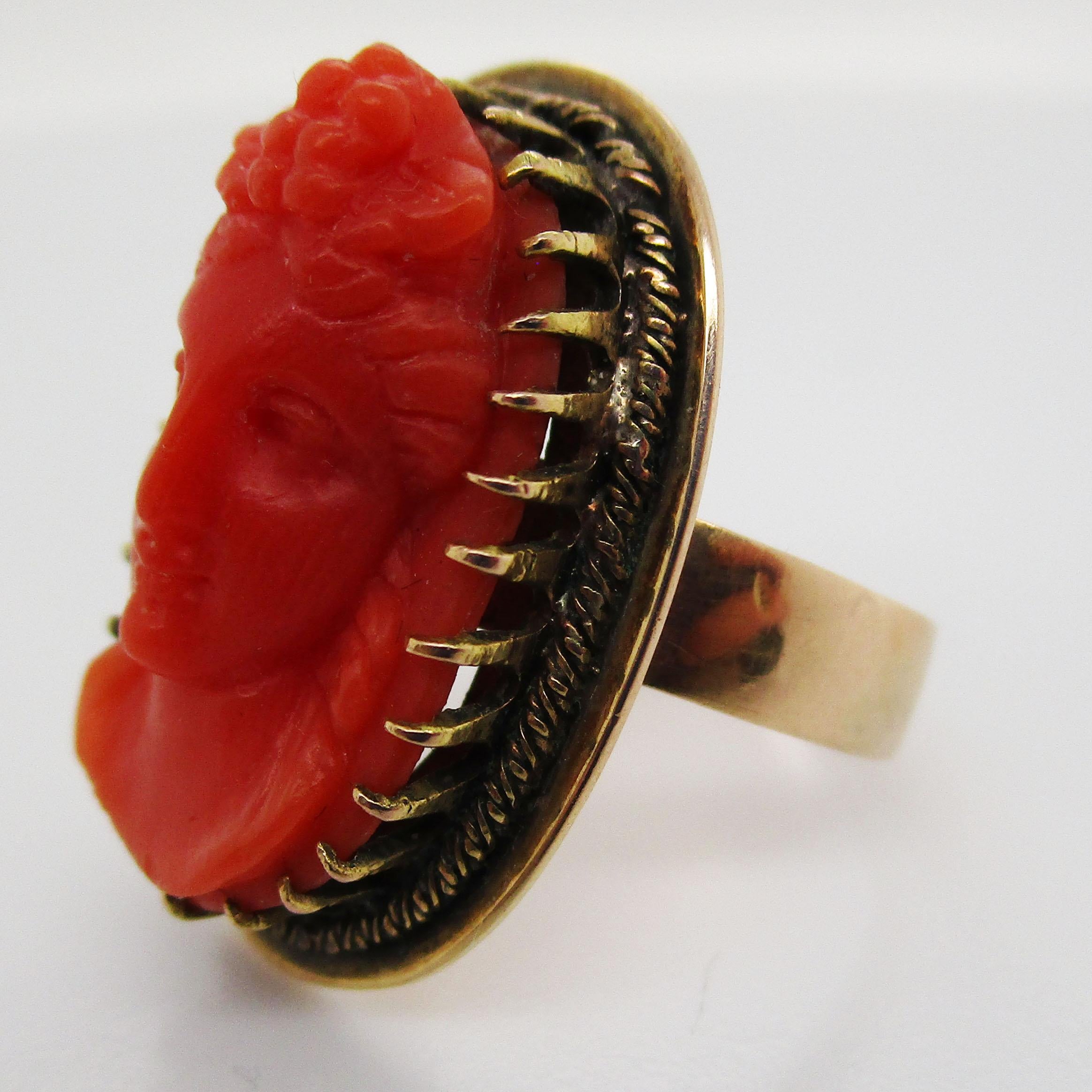 This gorgeous Victorian 14 karat yellow gold ring boasts a hand carved red coral cameo with truly stunning natural untreated color! The beautifully delicate carving is all original and complete, and shows absolutely remarkable detail and skill. The