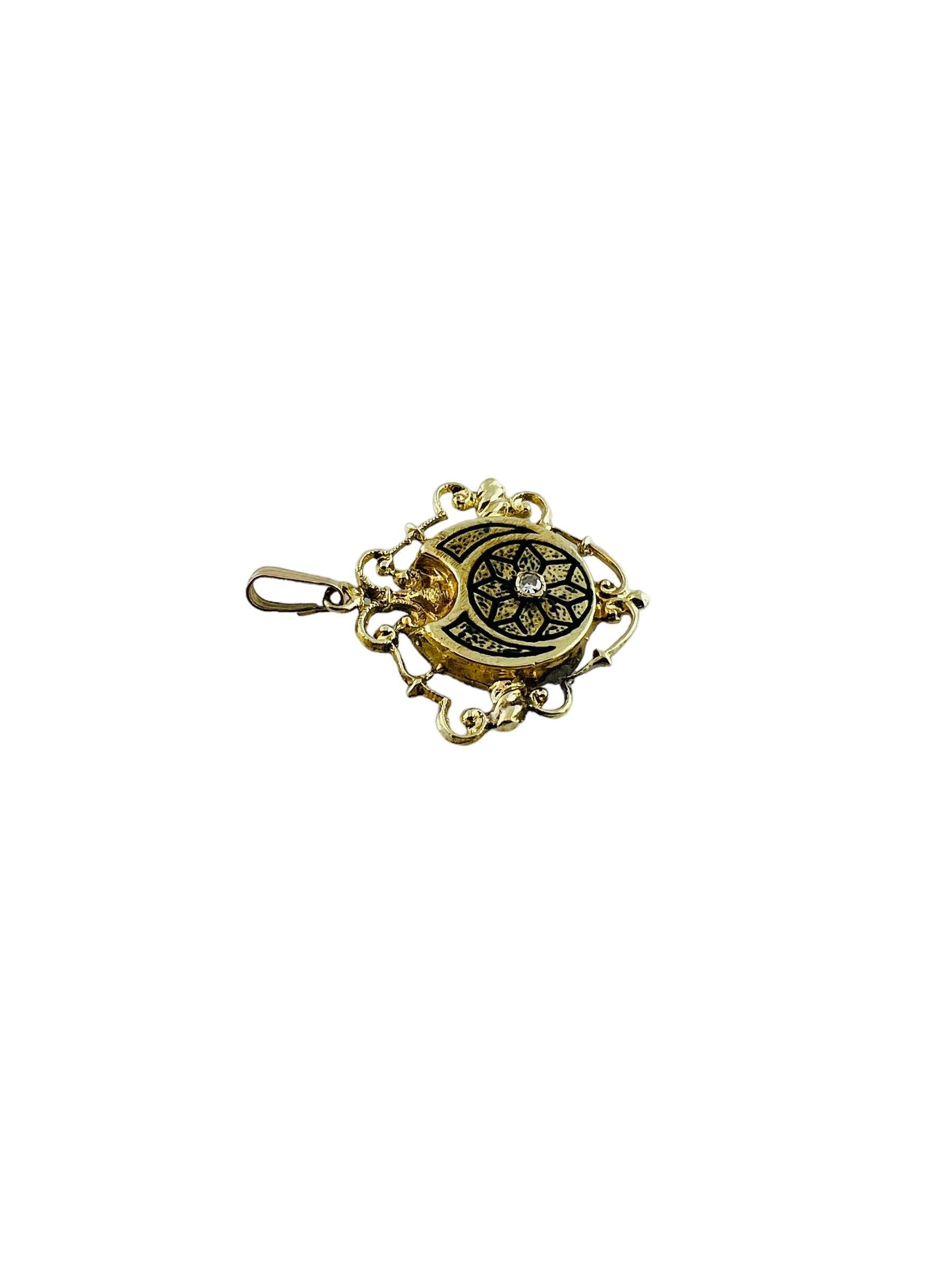 This beautiful yellow gold pendant is accented with black enamel in a flower design with a center single cut diamond.

The pendant has a shield like open design

Stamped 14K 83

Diamond is a single cut stone approx. .03 cts. I1 clarity and H