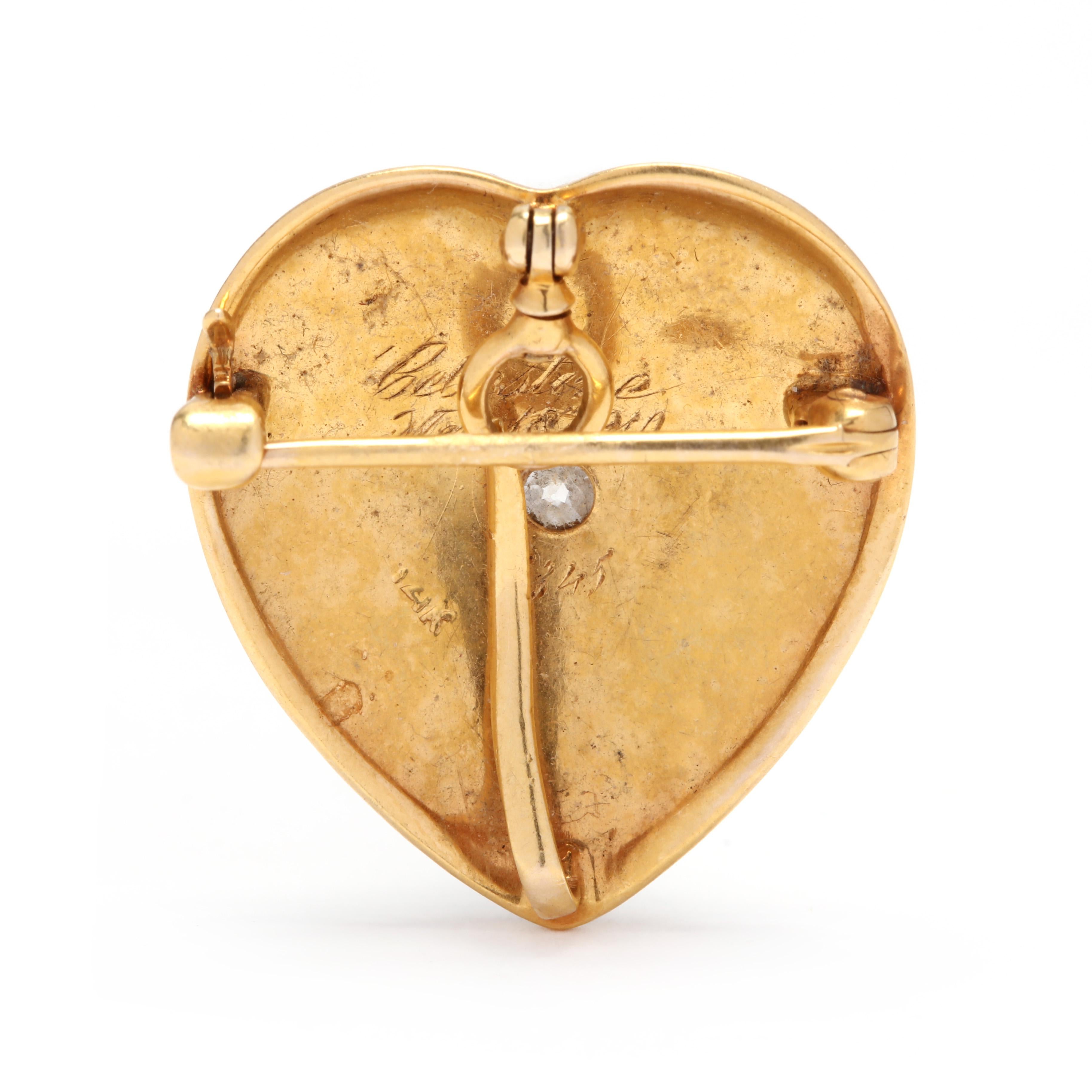 An antique 14 karat yellow gold diamond and seed pearl heart brooch and pendant. This pendant features a heart shape motif with a central old European cut diamond weighing approximately .11 carat surrounded by pavé set seed pearls. This brooch has a