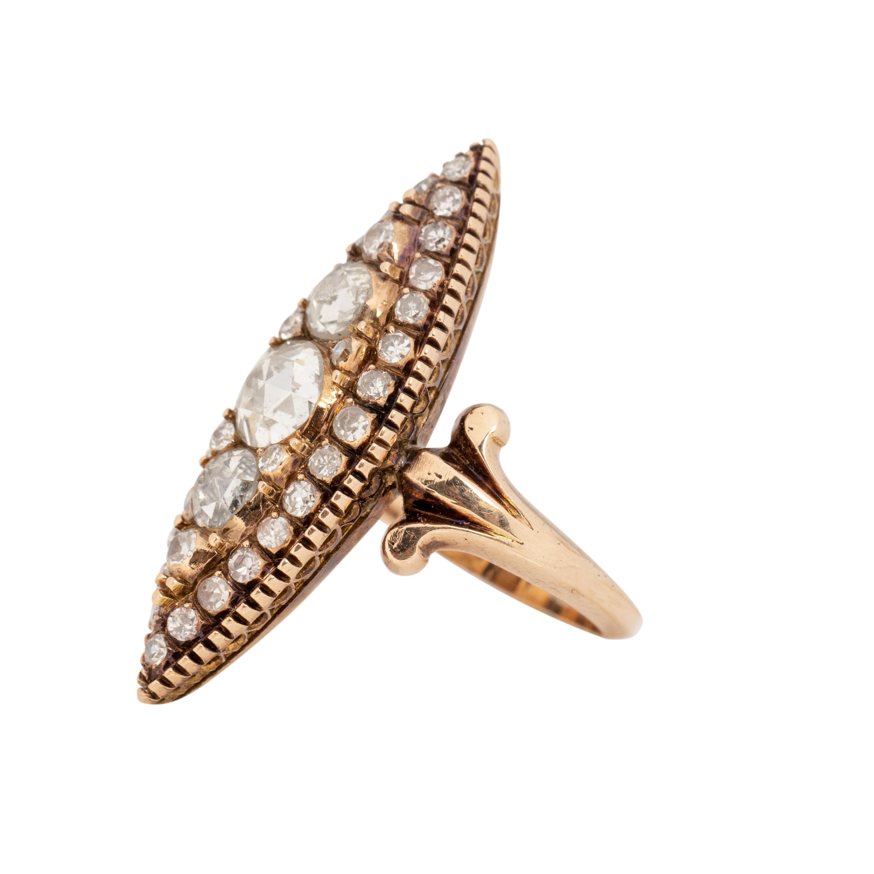This piece has a bold beautiful look that will have all the heads turning. Crafted in 14K Yellow gold, with beautiful rosy undertones the simple shanks hold a breathtaking navette shape accompanied by a variety rose cut diamonds. This shape is great