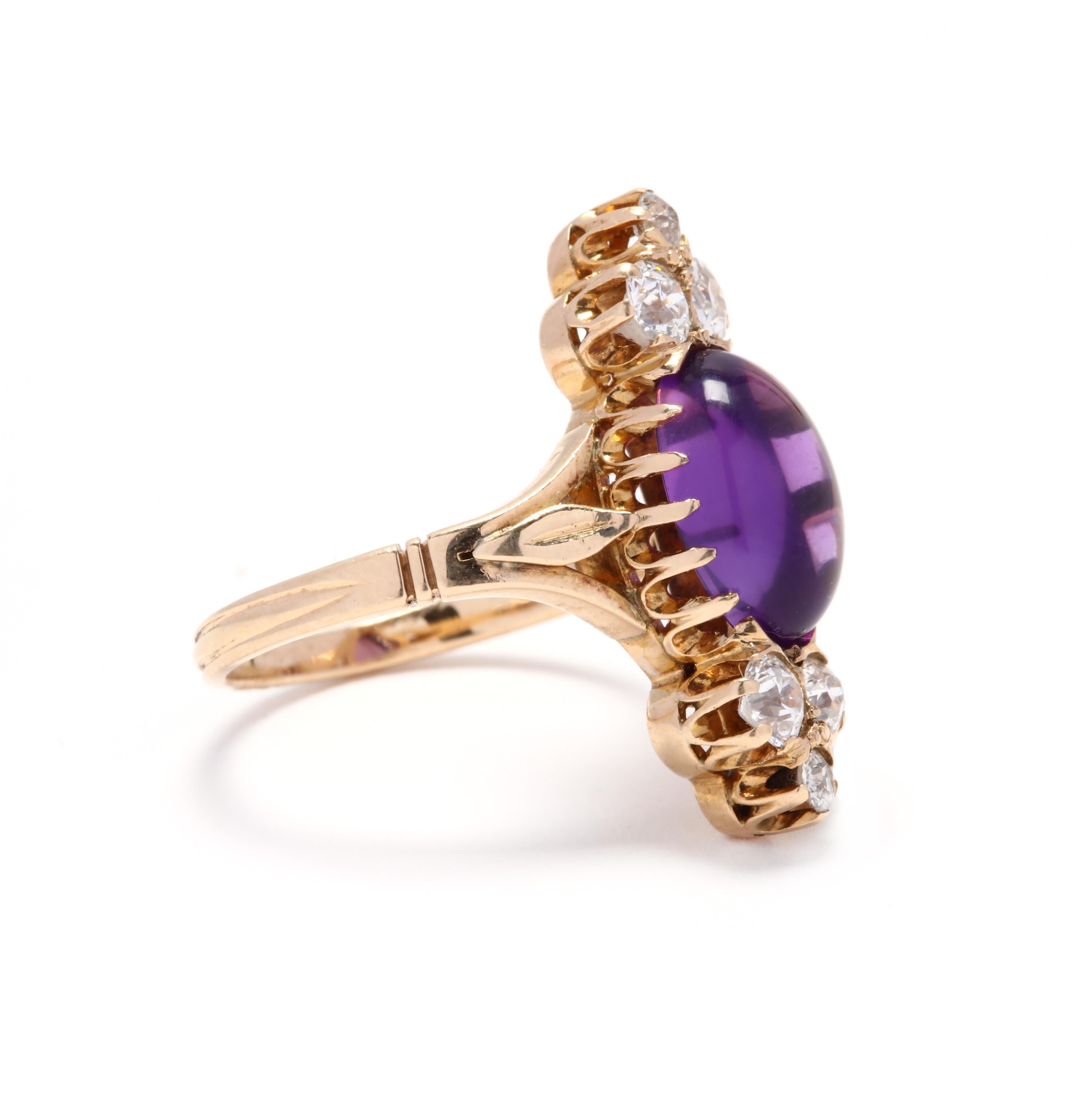 A Victorian 14 karat yellow gold, amethyst and diamond navette ring. This ring features a prong set, oval cabochon amethyst weighing approximately 2.77 carats with a trefoil design of old European cut diamonds weighing approximately .68 total carats