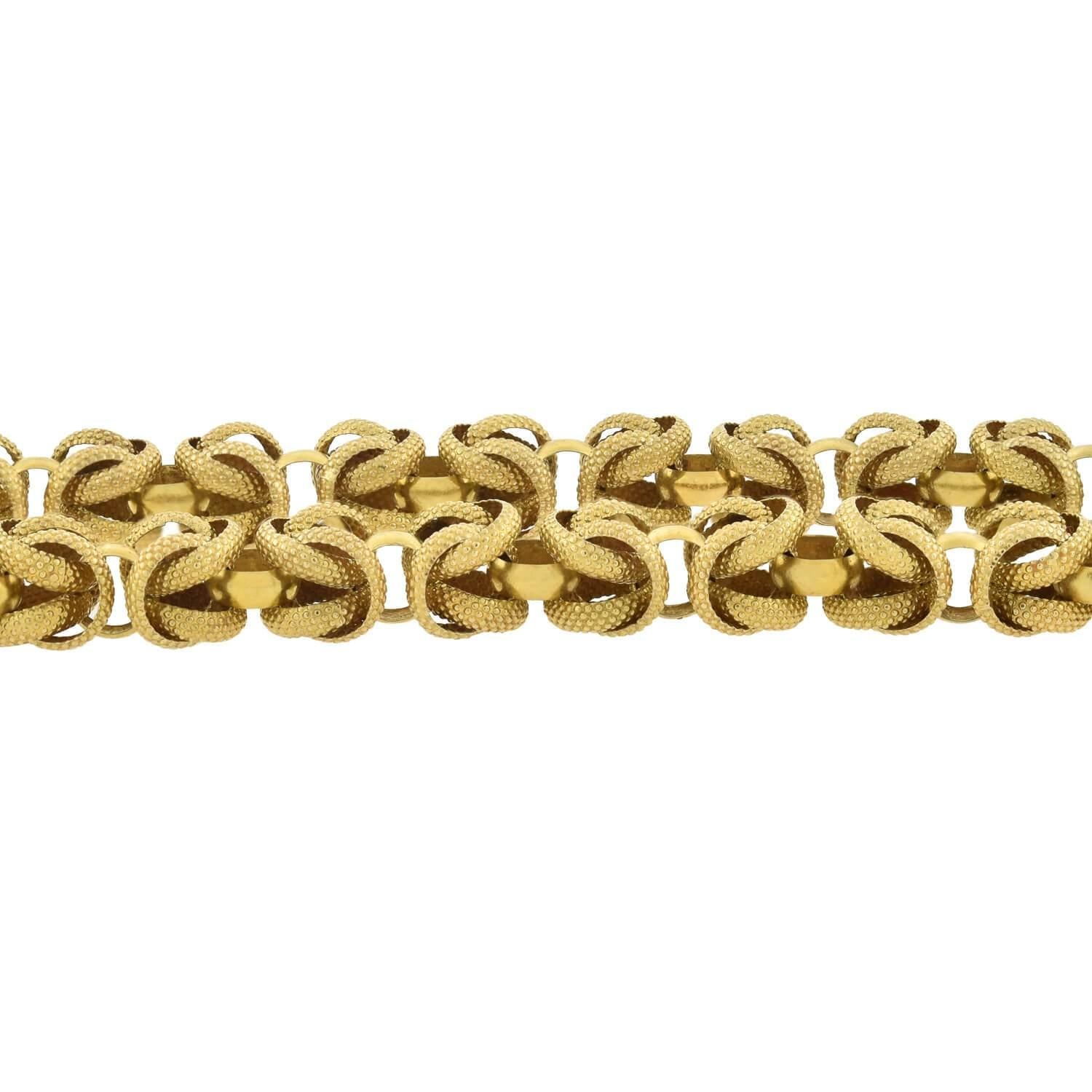 A very unusual gold chain from the Victorian (ca1880s) era! This exceptional handmade necklace is crafted in 14kt yellow gold and comprised of a multitude of interlocking rings that come together to form a unique pattern. Textured rings form