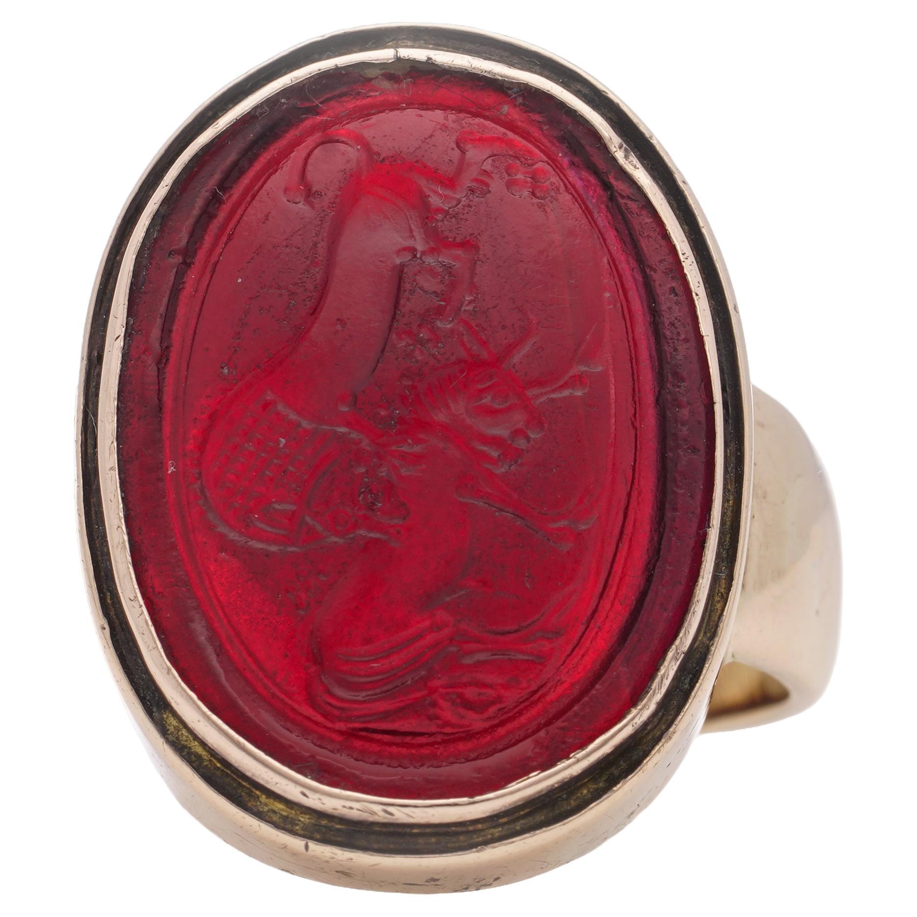 Victorian 14kt. rose gold red pique glass intaglio, featuring lion attack  For Sale