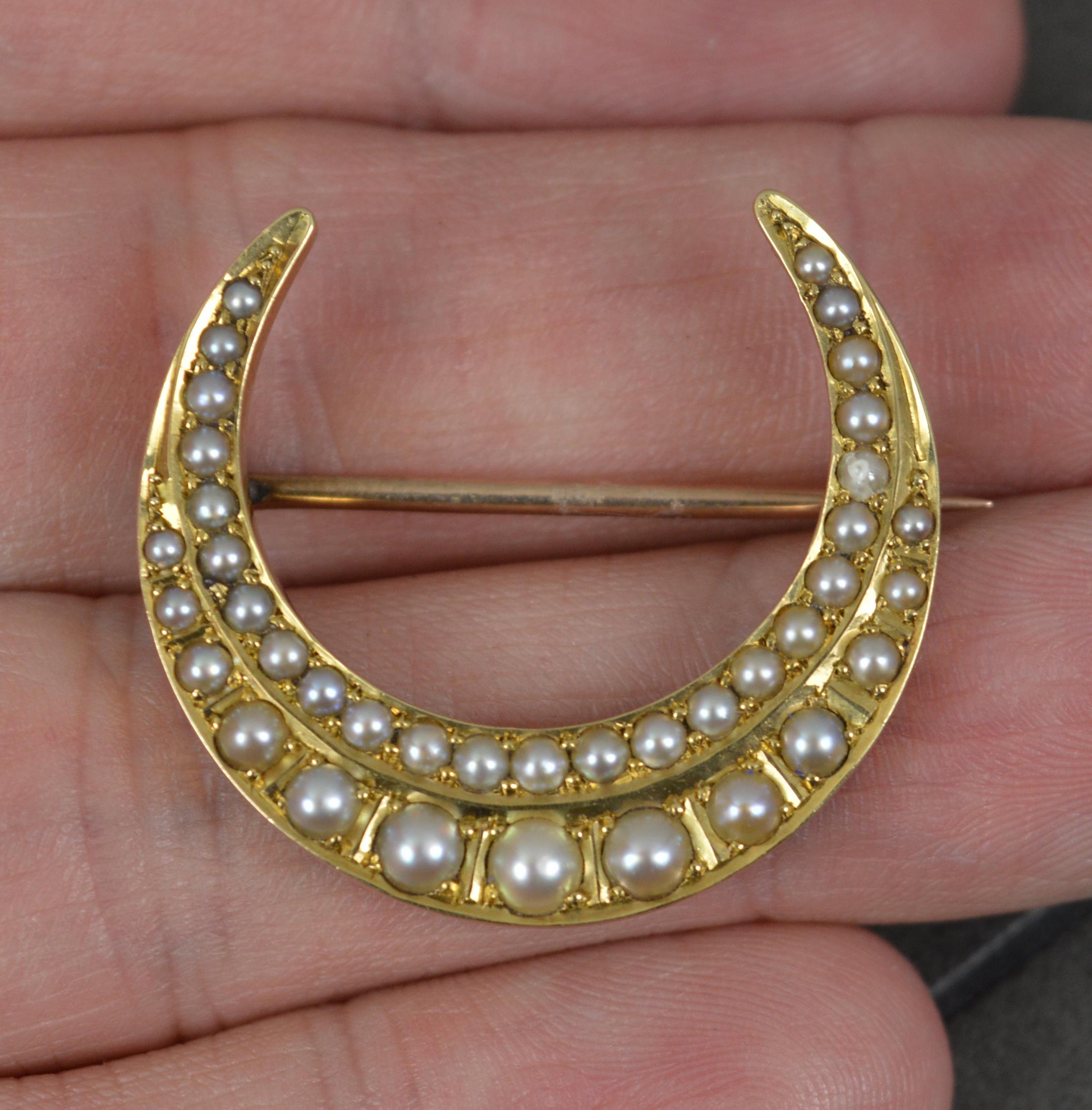 A late Victorian period brooch.
Solid 15 carat yellow gold example.
Set with natural pearls of graduated size of two row design.
An ever popular crescent shape.

CONDITION ; Excellent. Crisp pattern. Working pin and hinge. Securely set pearls. All
