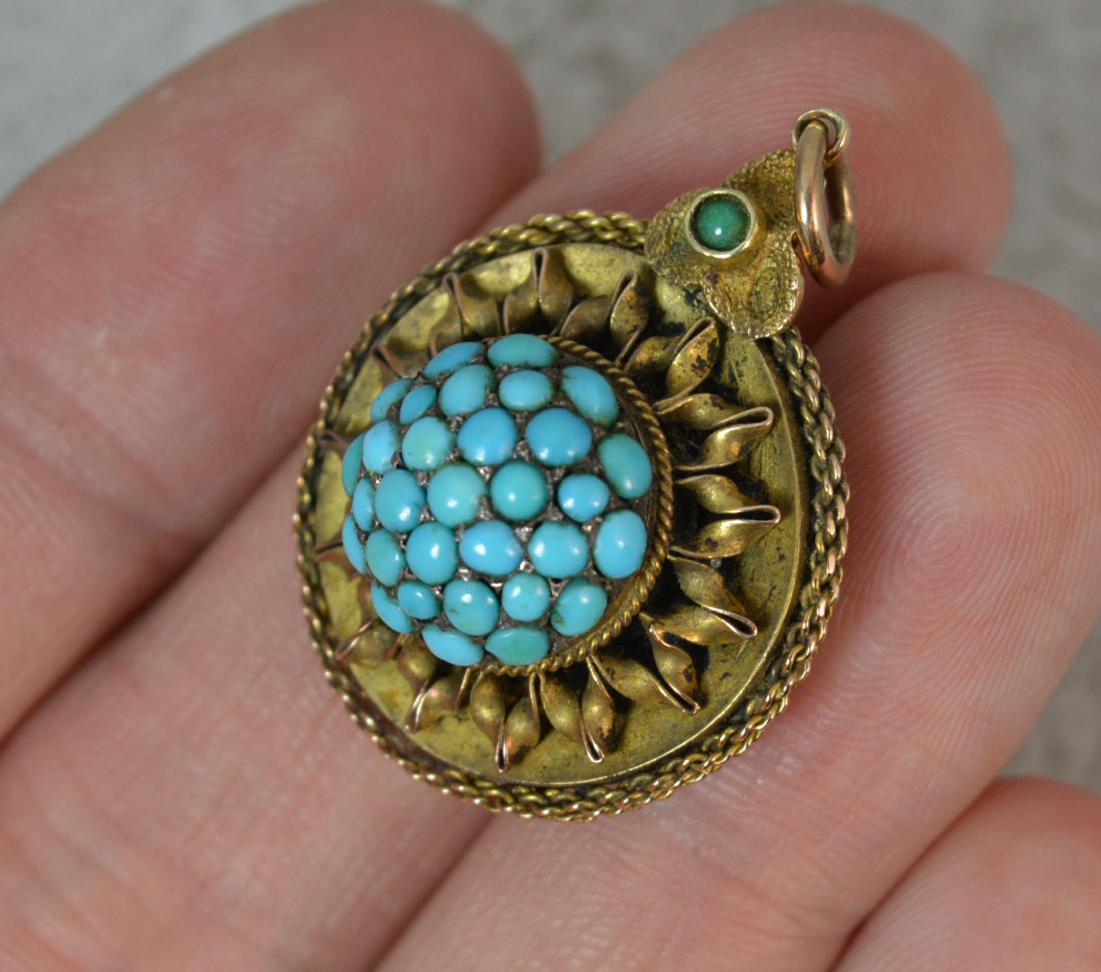 A fantastic early to mid Victorian pendant.
Modelled in 15 carat yellow gold throughout.
Designed with a pave set bombe cluster of turquoise stones to centre with a petal like gold surround and twist link edge. Complete with locket