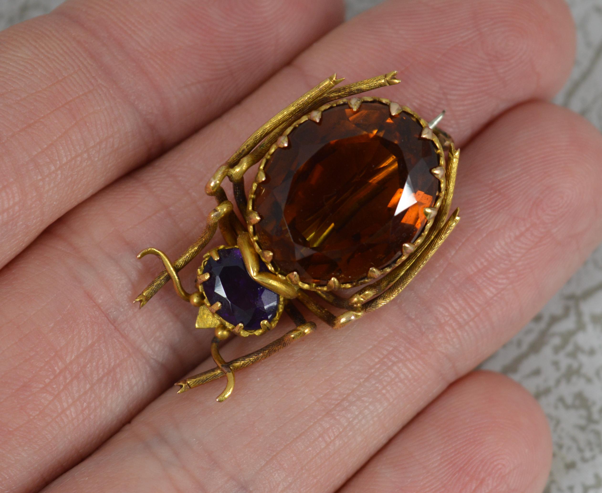 A superb late Victorian period brooch.
Solid 15 carat yellow gold example.
Formed as a beetle or insect. Designed with a large oval deep orange citrine to the body and a smaller oval deep purple amethyst.

CONDITION ; Excellent for age. Crisp