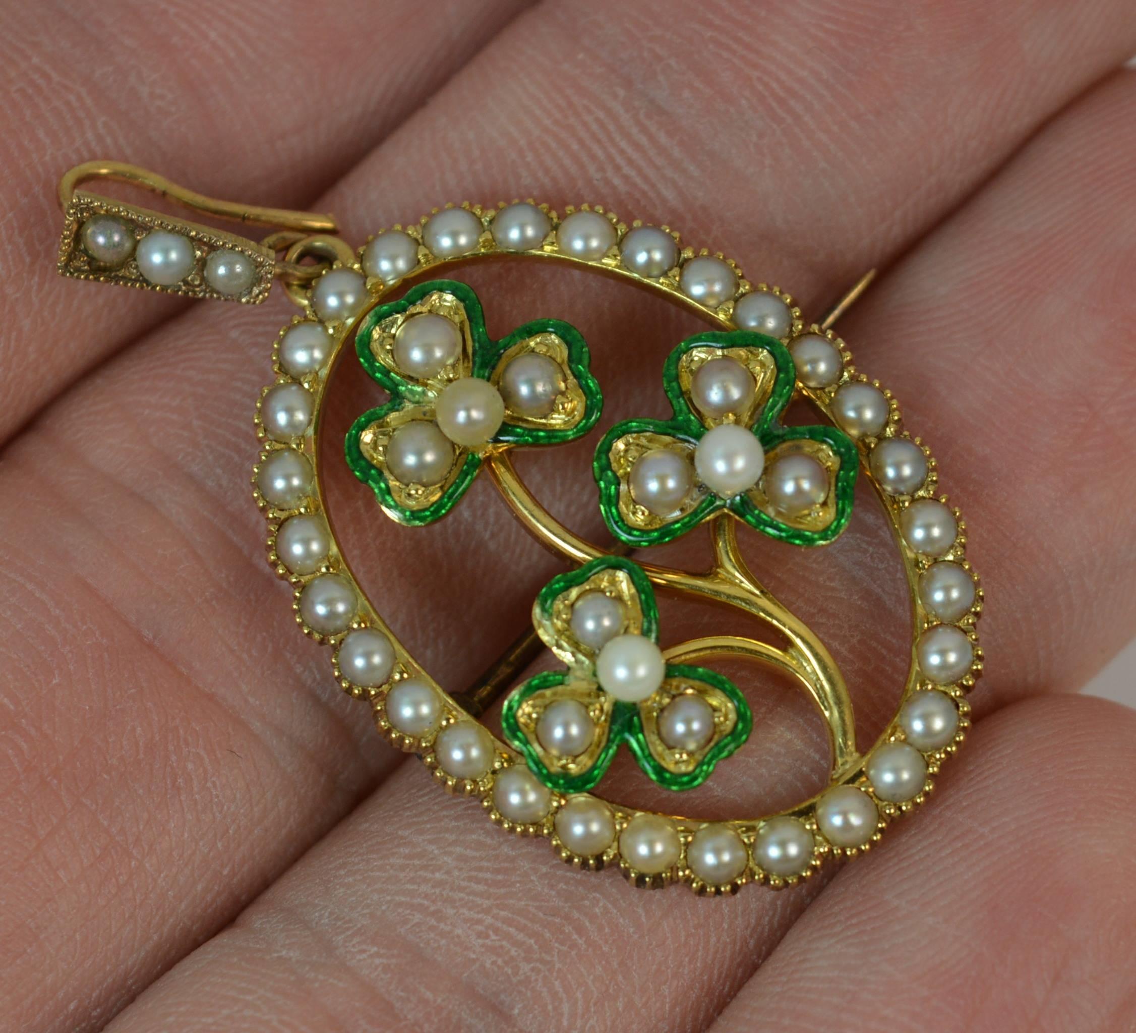 
A beautiful antique pendant brooch.

Solid 15 carat yellow gold example.

​Designed with a full border of seed pearls and further pearls to the bale. To the centre is a set of three three leaf clovers with further seed pearls and green enamelled to