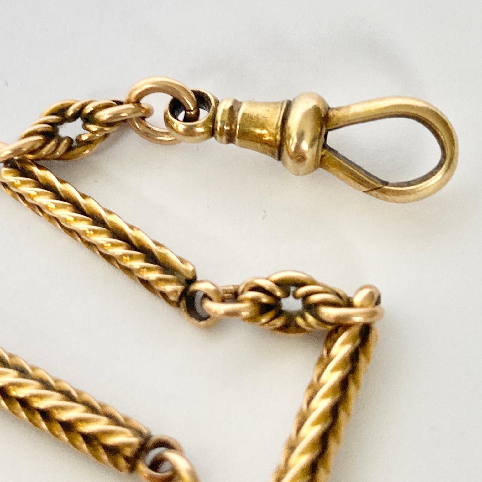 This gorgeous Albert has highly decorative links in it. One of the styles is a twisted square shaped link and the other is layered, knotted and twisted. There is a t-bar and tassel at one end and dog end at the other. 

Length: 28cm 
Width: 4mm
