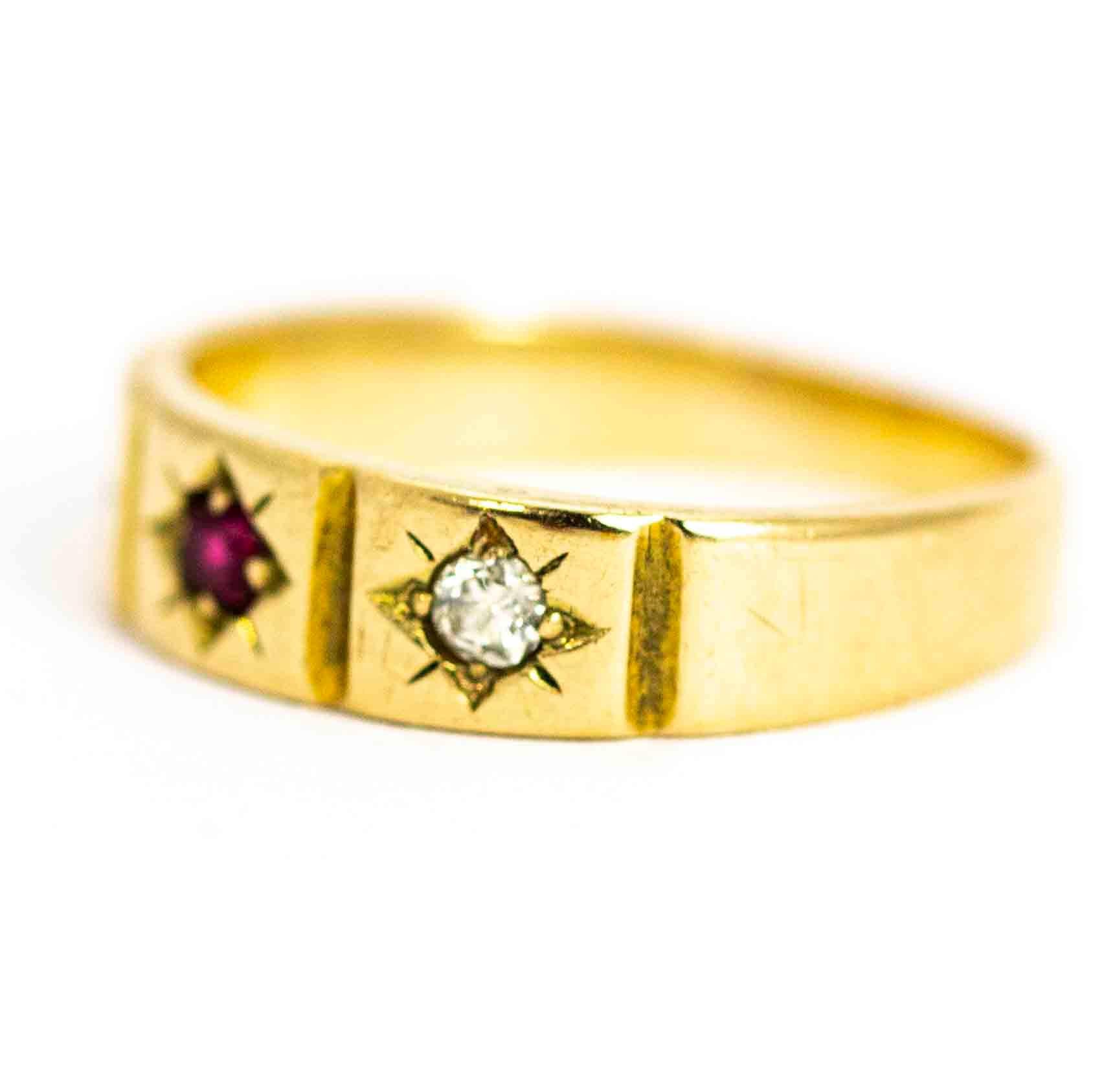 A beautiful antique mid-Victorian three-stone ring. Set with a central round ruby flanked by old European cut white diamonds measuring approximately 5 points each.  The stones each sit in fine chased panels. Modelled in 15 carat yellow gold. Fully