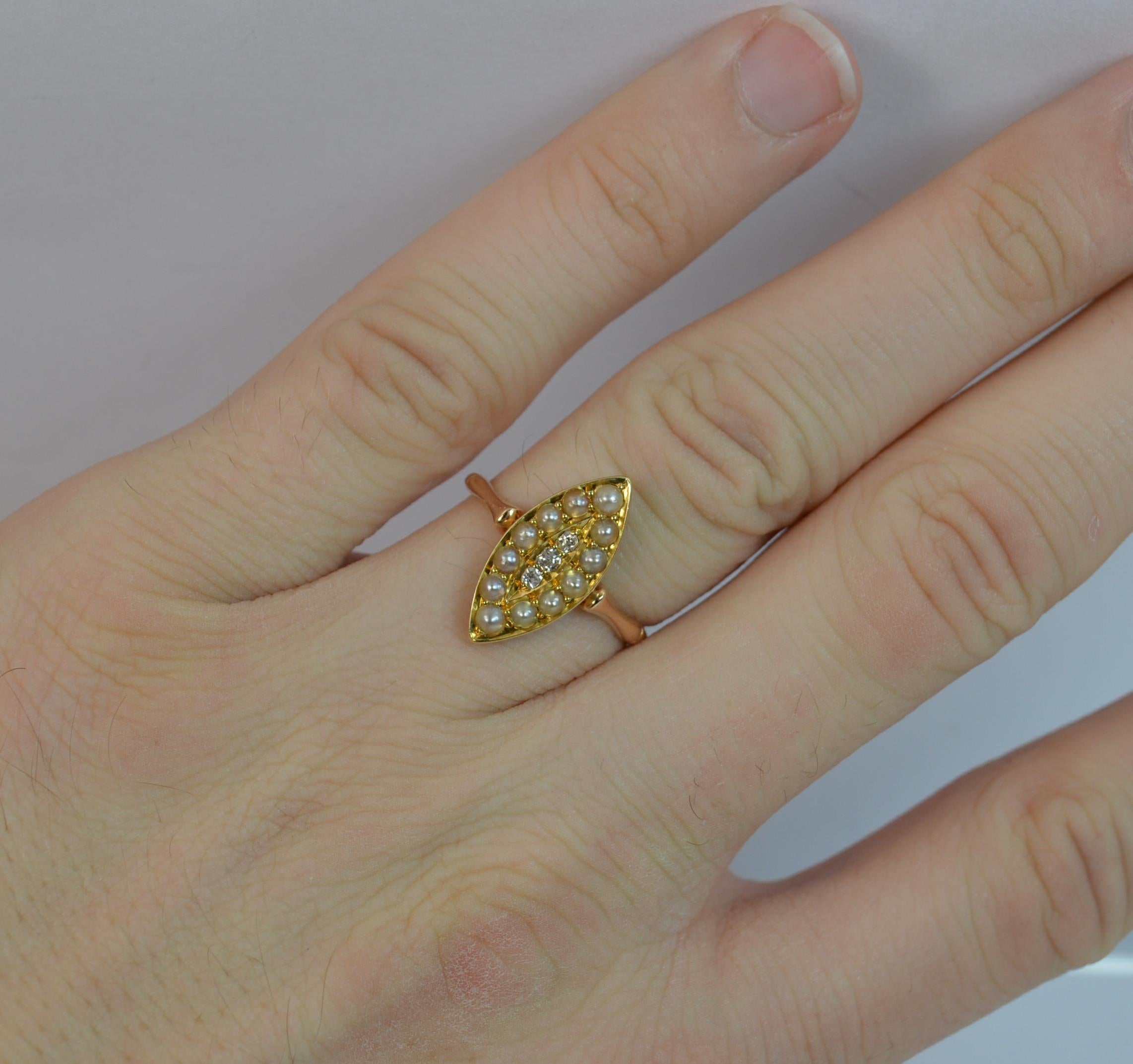 
A lovely Victorian period navette shaped ring.

Solid 15 carat rose gold shank and head with yellow gold setting.

​Designed with three old cut diamondsto the centre with a full seed pearl border.

​8mm x 17mm cluster head. Circa 1880.

CONDITION ;