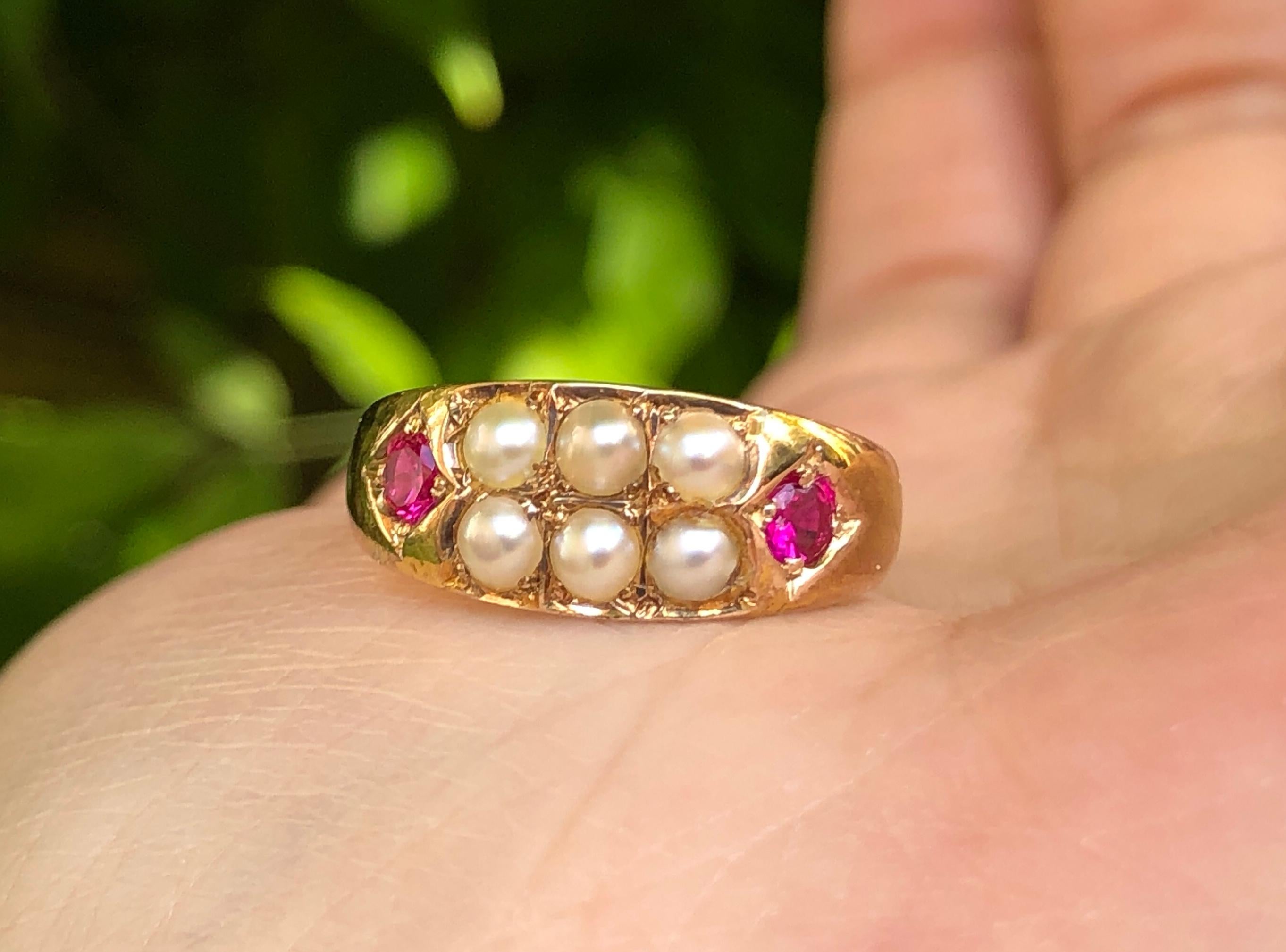 A lovely quality antique Victorian 15 carat yellow gold ring with two round-cut rubies and seed pearls in a gypsy setting. The shank is stamped with  Chester marks to the interior of the band.

It is currently a size  L 1/2 (UK), 6 (US), and can be