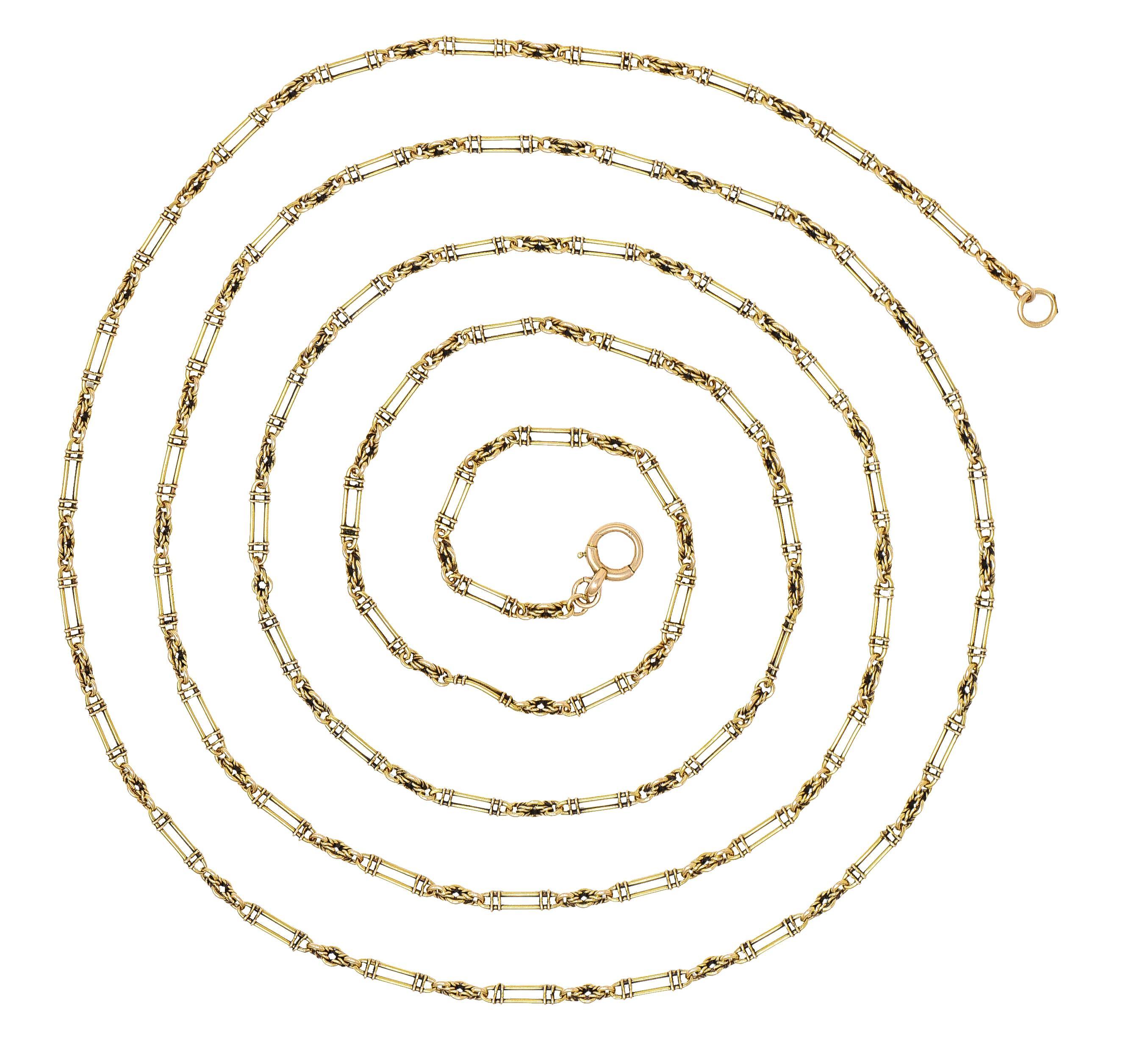 Comprised of elongated oval wire links accented by wrapped segments
Alternating with stylized wire-wrapped cable link chain
Completed by large spring clasp closure
Stamped for 15 karat gold 
With partial maker's mark 
Circa: 1860's
Width at widest:
