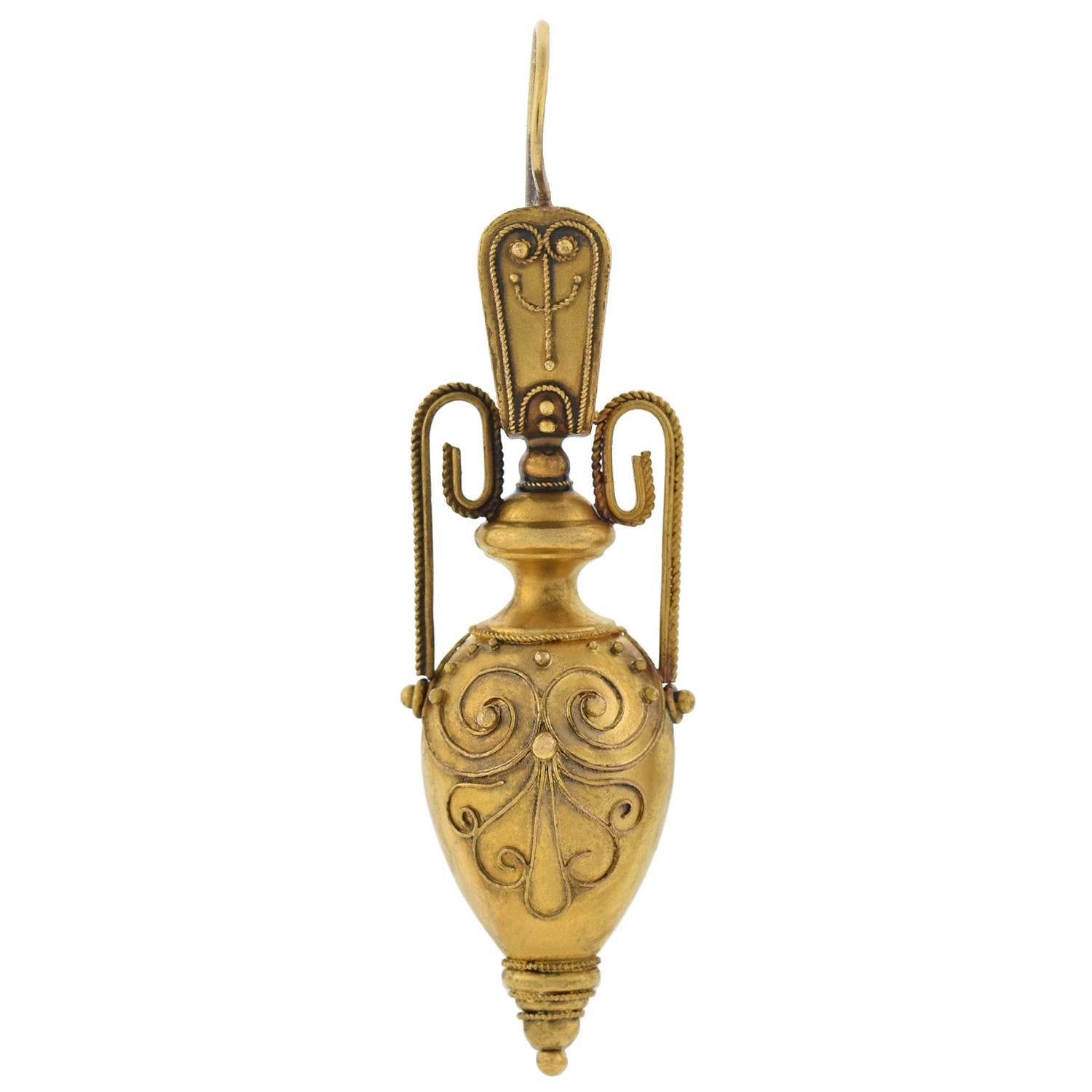 A stunning pair of Etruscan urn earrings from the Victorian (ca1880) era! Crafted in 15kt yellow gold, each 3-dimensional shaped piece displays a smoothly polished surface with wonderful Etruscan details. Adorning the front surface of each urn are