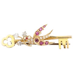 Antique Victorian 15 Karat Yellow Gold Key with a Ruby and Diamond Swallow Brooch
