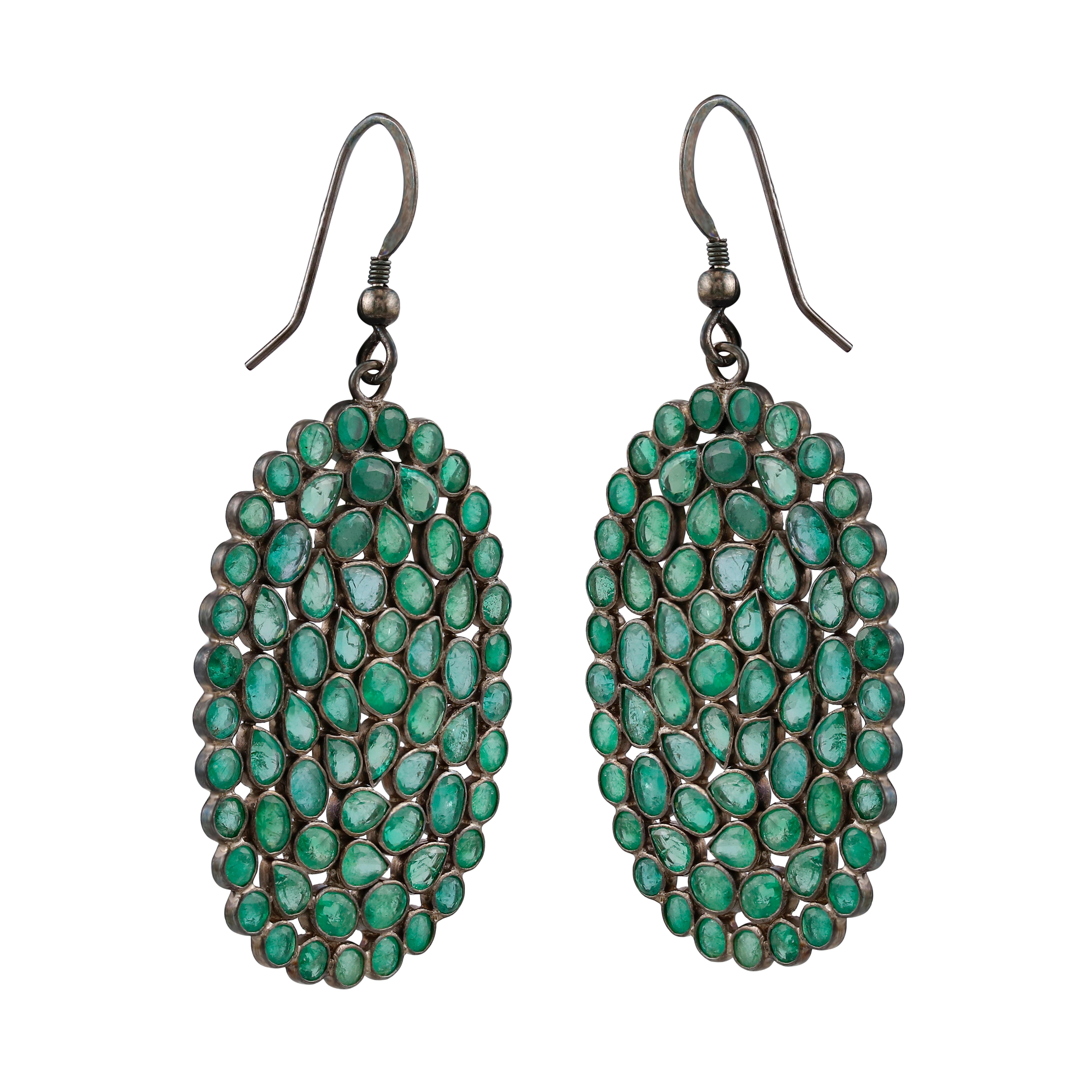 These sparkling danglers each include a great assortment of stones. These vibrant emerald gemstones are wonderful, arranged in pretty oval shapes. These earrings are handmade in sterling silver and are accompanied with lever backs.

Please follow