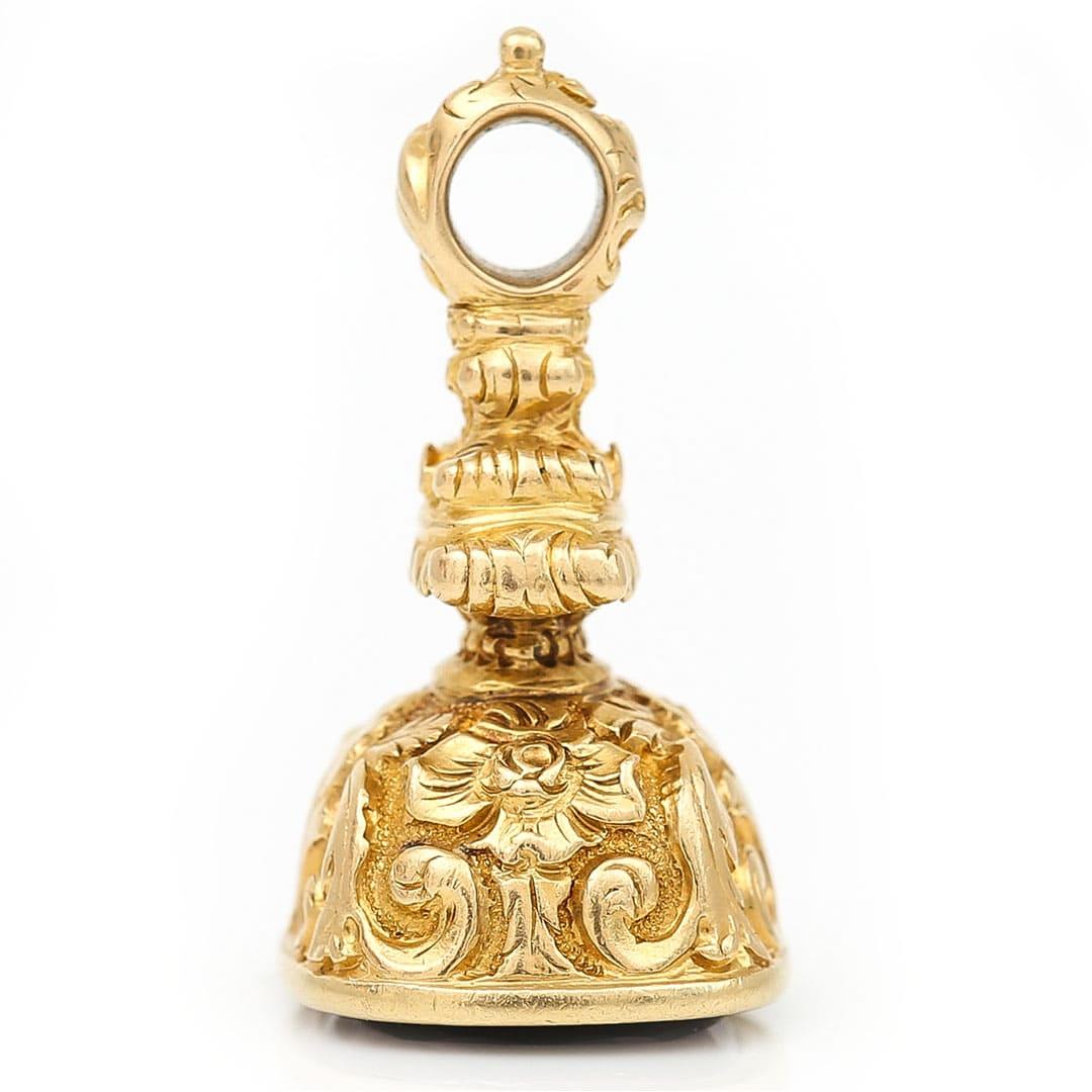 A wonderful Victorian 15ct gold fob seal that has the masterfully carved name Caroline to its amethyst base and dates from circa 1880. The body of the seal of ornate design has all its delighting intact with fine cursive and applied filigree styling