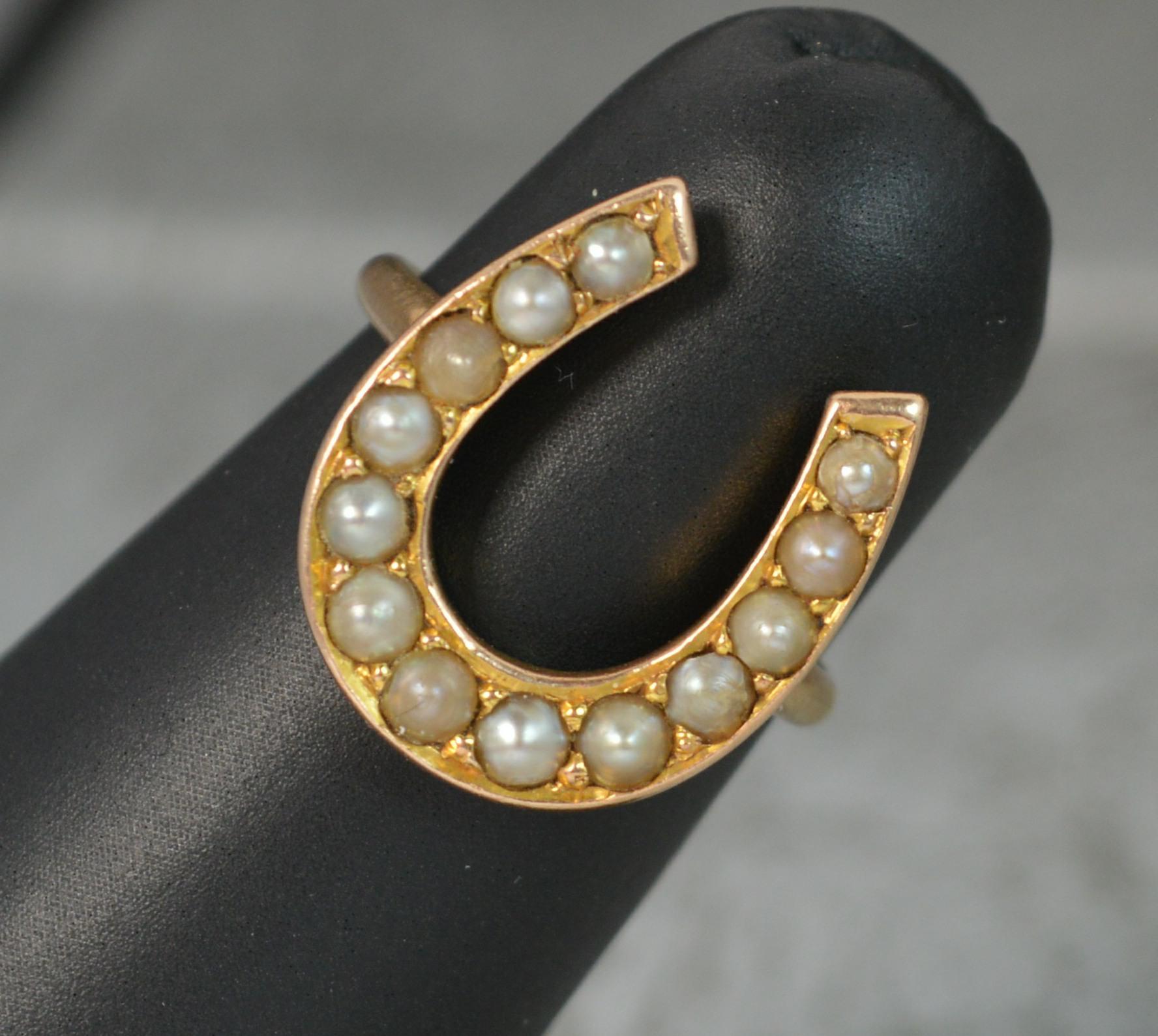 A beautiful Victorian period ring.
Solid 15 carat gold example.
Designed as a good luck horse shoe symbol to the front which measures 14mm x 17mm approx.
The horseshoe is set with unlucky for some thirteen natural seed pearls.
CONDITION ; Very good