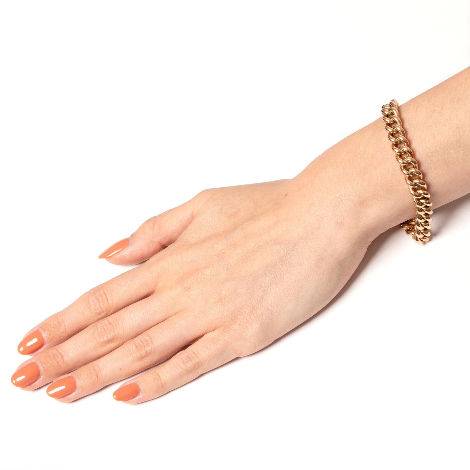 Dating back to the Victorian period, this rounded curb link bracelet has been crafted in 15 carat gold. Measuring 18cm in length, the bracelet fits comfortably, secured by a discreet box clasp, with a safety chain added for peace of mind. Each link