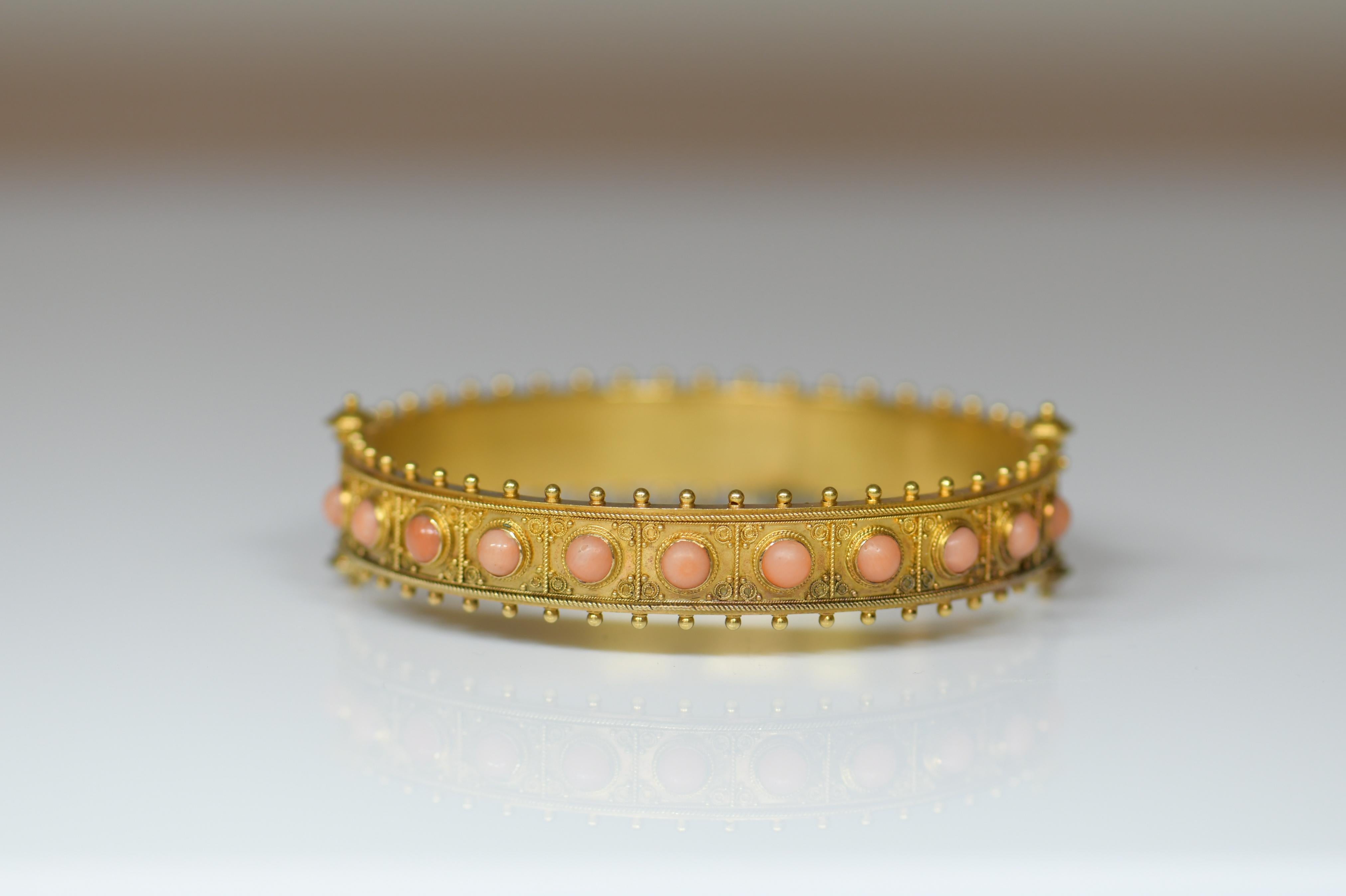 A good quality 15ct gold coral bangle that was made circa 1880. At that time there was a movement called the Etruscan Revival as many finds from the Etruscan period were being unearthed in Italy. Jewellers at the time embraced the challenge of