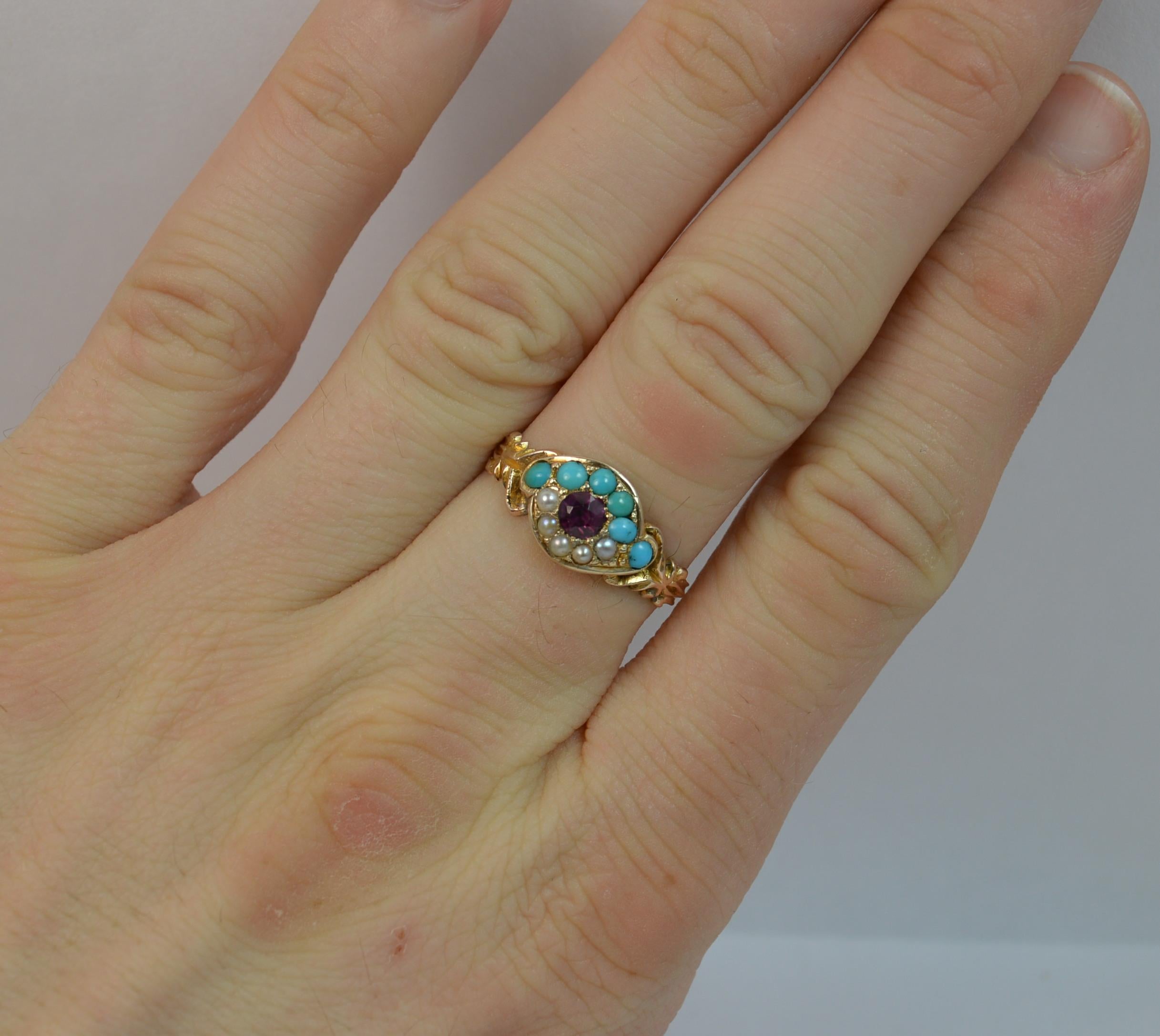 An early Victorian period 'all seeing eye' cluster ring. Modelled in a high carat gold and designed with a garnet to the centre and turquoise and seed pearl surround.
Size P 1/2 UK, 8 US
8.7mm wide band to the front.

2.0 grams. Securely set stones.