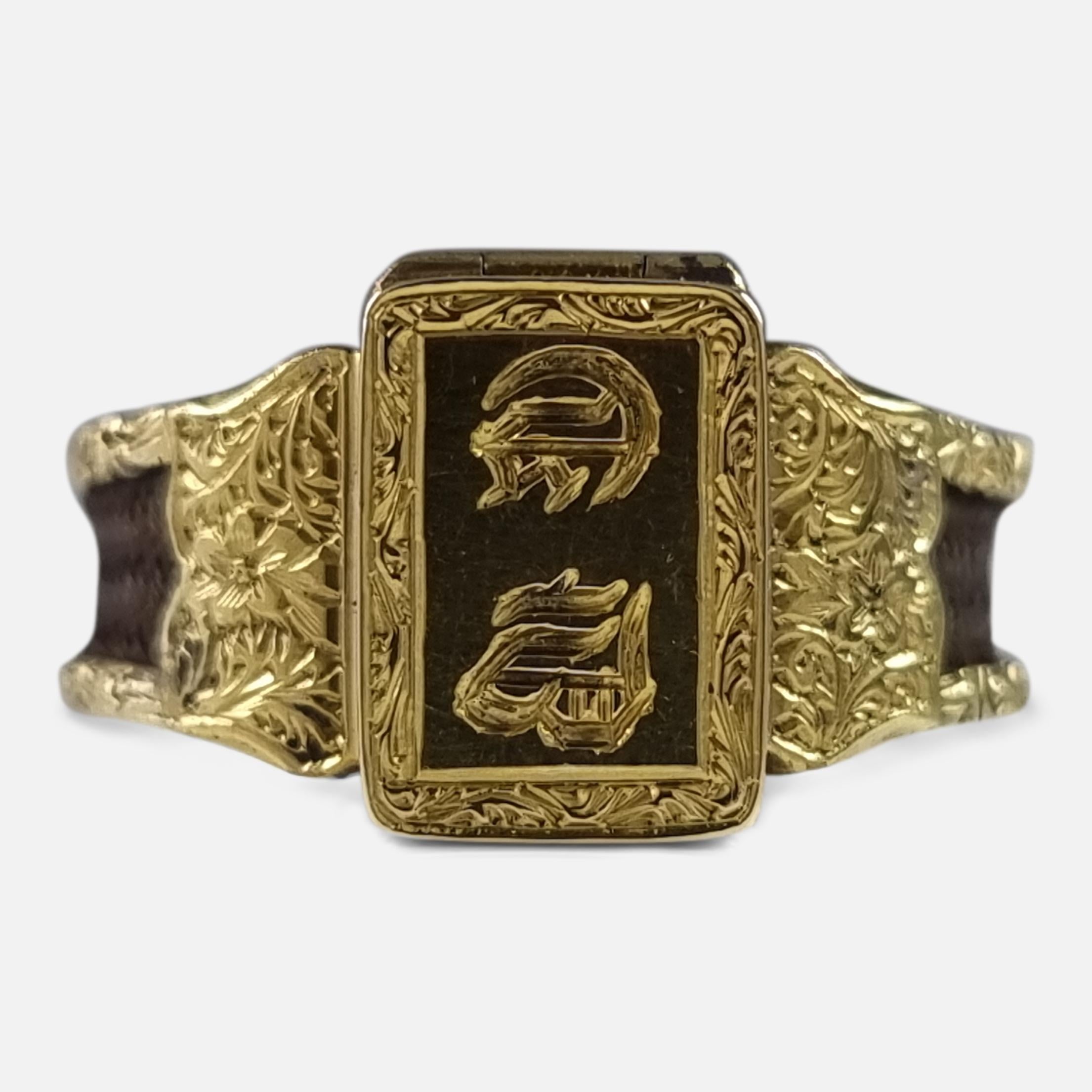 A Victorian 15 carat yellow gold sentimental memorial portrait hair-work ring. The ring has an engraved panel to the front with a pair of initials, which hinges open upwards to reveal a coloured portrait of a Victorian woman, leading to scrolling