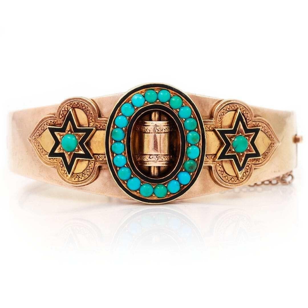 A super Victorian 15ct gold turquoise bangle with black enamel detailing around the two star motifs. This bangle is archetypal of the era with central cartouche and applied strap work detail, all inlaid with turquoise. With some engraved detail to