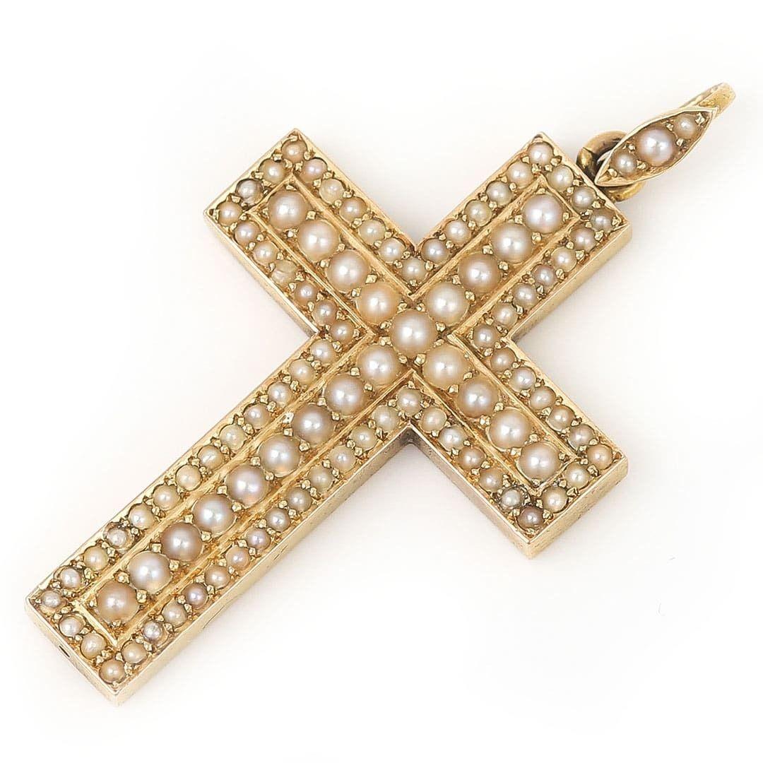 A beautiful and stylish Victorian 15ct yellow gold, graduated half pearls encrusted cross or cruciform pendant with pearl encrusted bale, hand crafted circa 1860. The half pearls of creamy, silver lustre are claw set with the larger pearls across