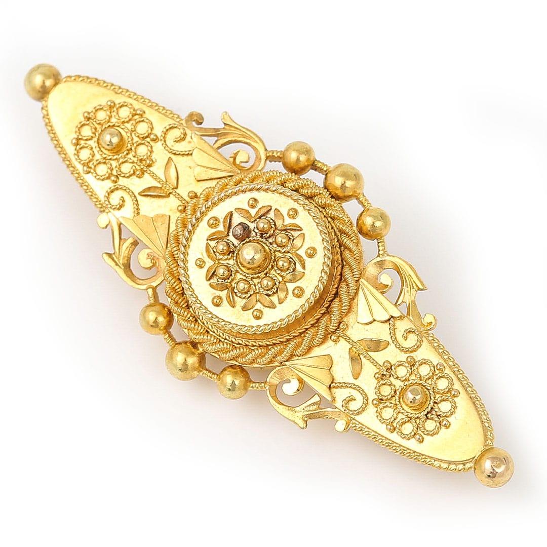 A stunning 15ct yellow gold Victorian Etruscan Revival propeller brooch finished in a delightful mat/satin finish featuring a central motif adorned with granulation and bead work. Dating from the late 19th century, and hallmarked for Chester 1899,