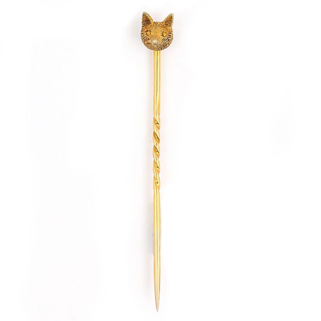 A dainty and immaculate late Victorian 15k yellow gold fox head stick pin, dating from England circa 1890. The naturalistic fox head hand crafted in a pleasing buttery and rich 15k yellow gold with deeply and intricately engraved detail. The fox has