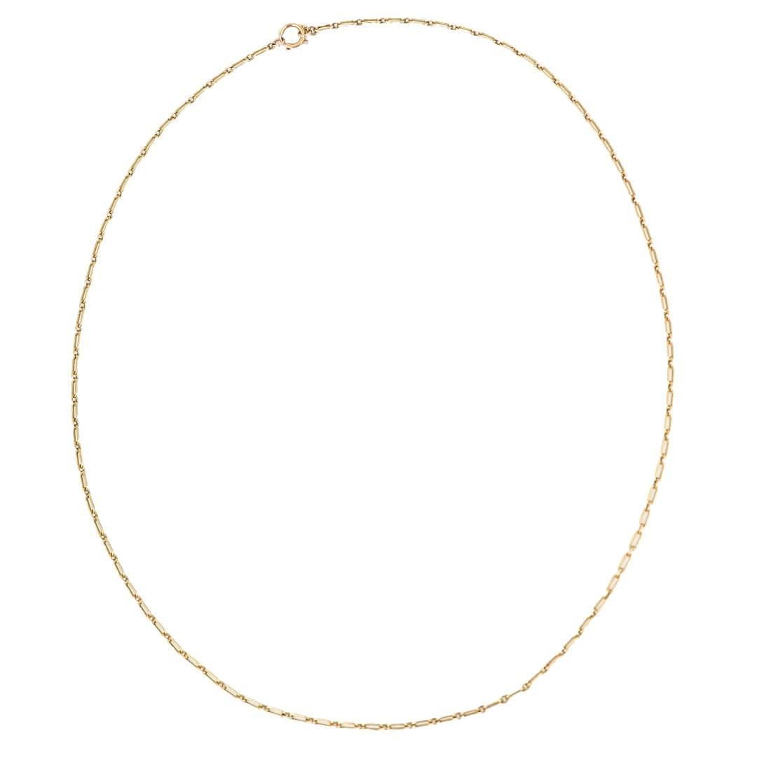 A wonderful late 19th century long guard or �‘muff’ chain hand crafted in buttery 15ct yellow gold. The long fetter, sometimes referred to as ‘trombone’ links are interpreted with single round links and in total the chain measures a great, versatile