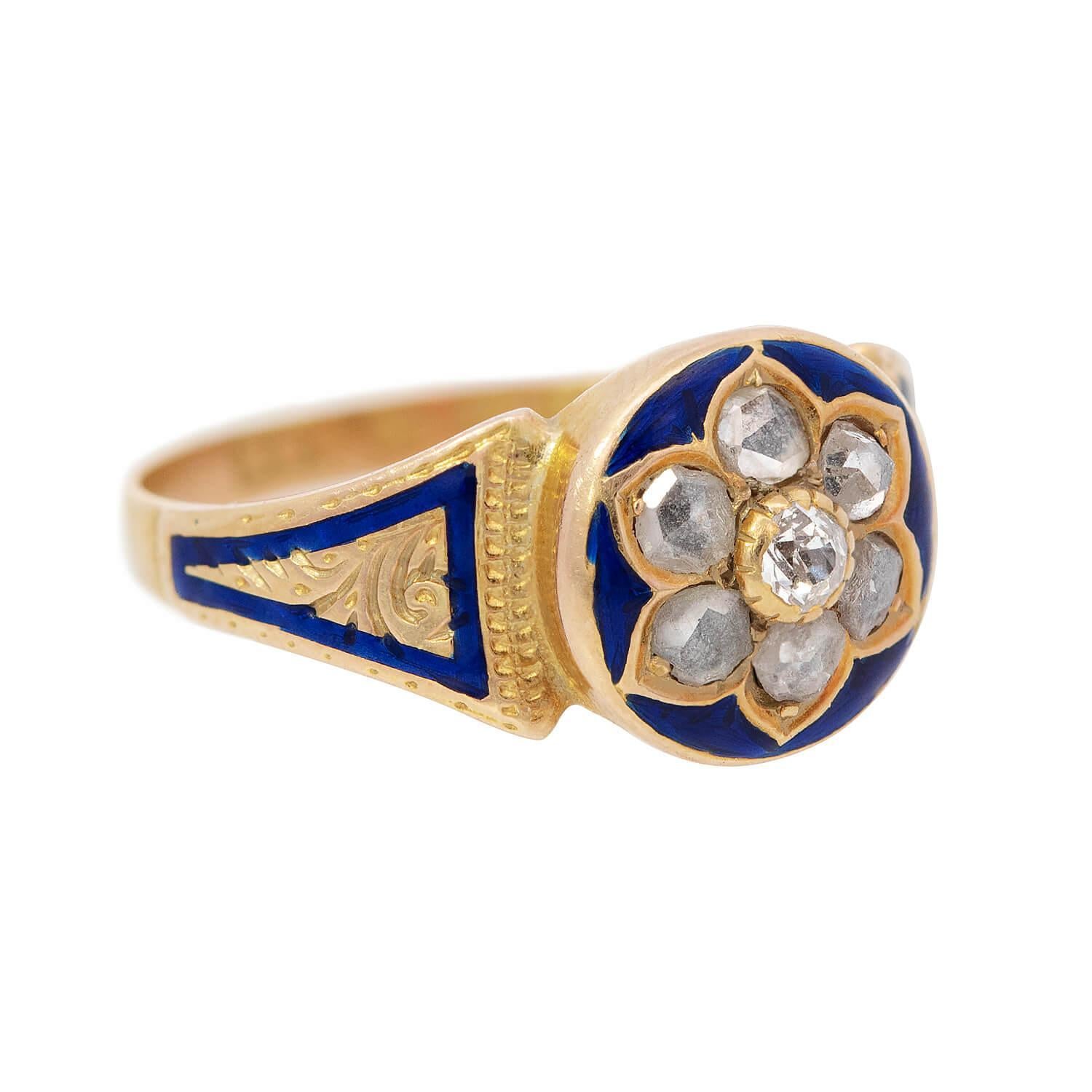 An exquisite diamond ring from the Victorian (ca1880s) era! Crafted in 15k yellow gold, the ring features seven rose cut diamonds which form a flower motif. The central diamond is held within a scalloped bezel setting, and the remaining six stones