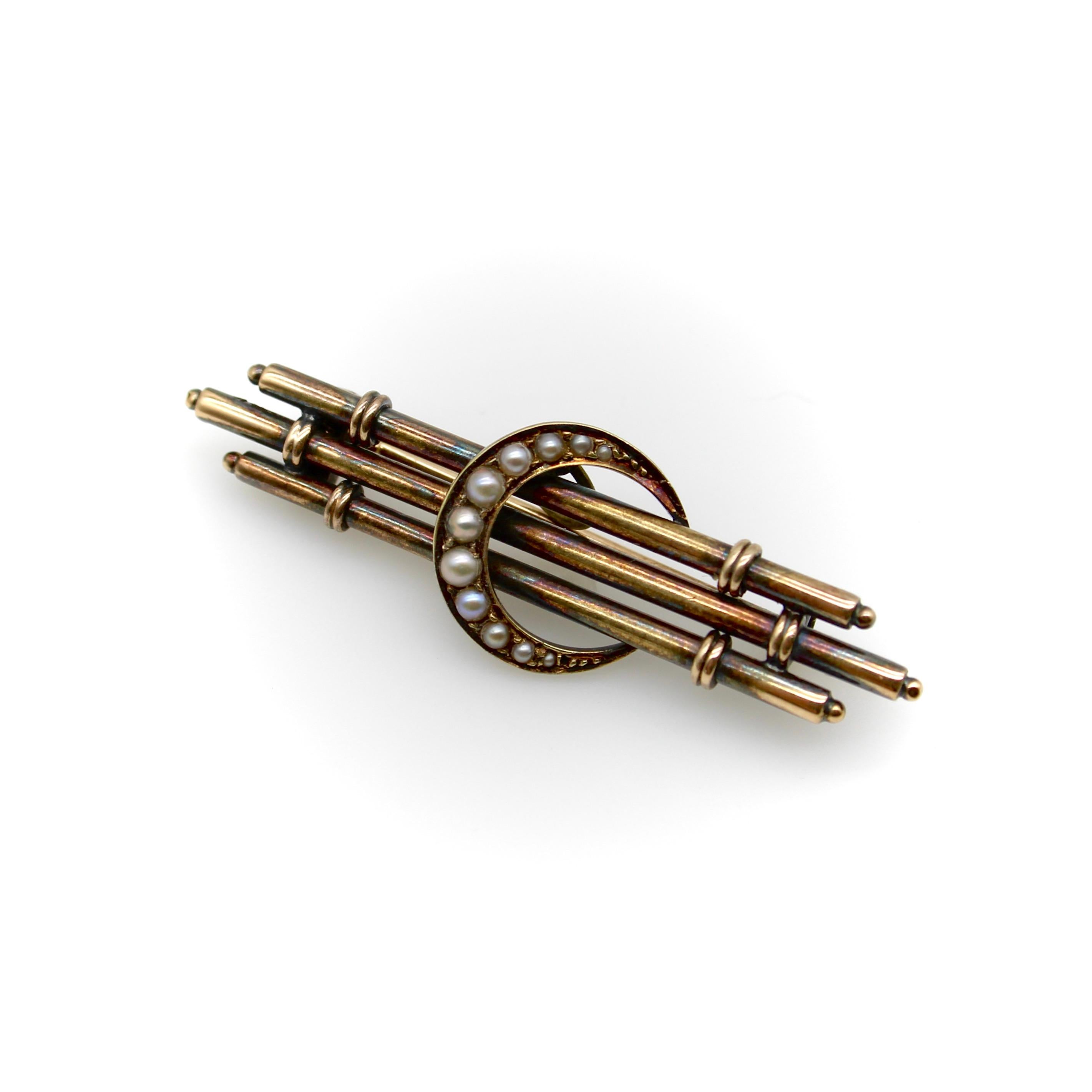 Este broche victoriano presenta una luna creciente que biseca elegantemente tres barras cilíndricas, creando un bonito equilibrio y sustancia a la pieza. La luna está incrustada de perlas de siembra engastadas y graduadas en tamaño. Las tres barras