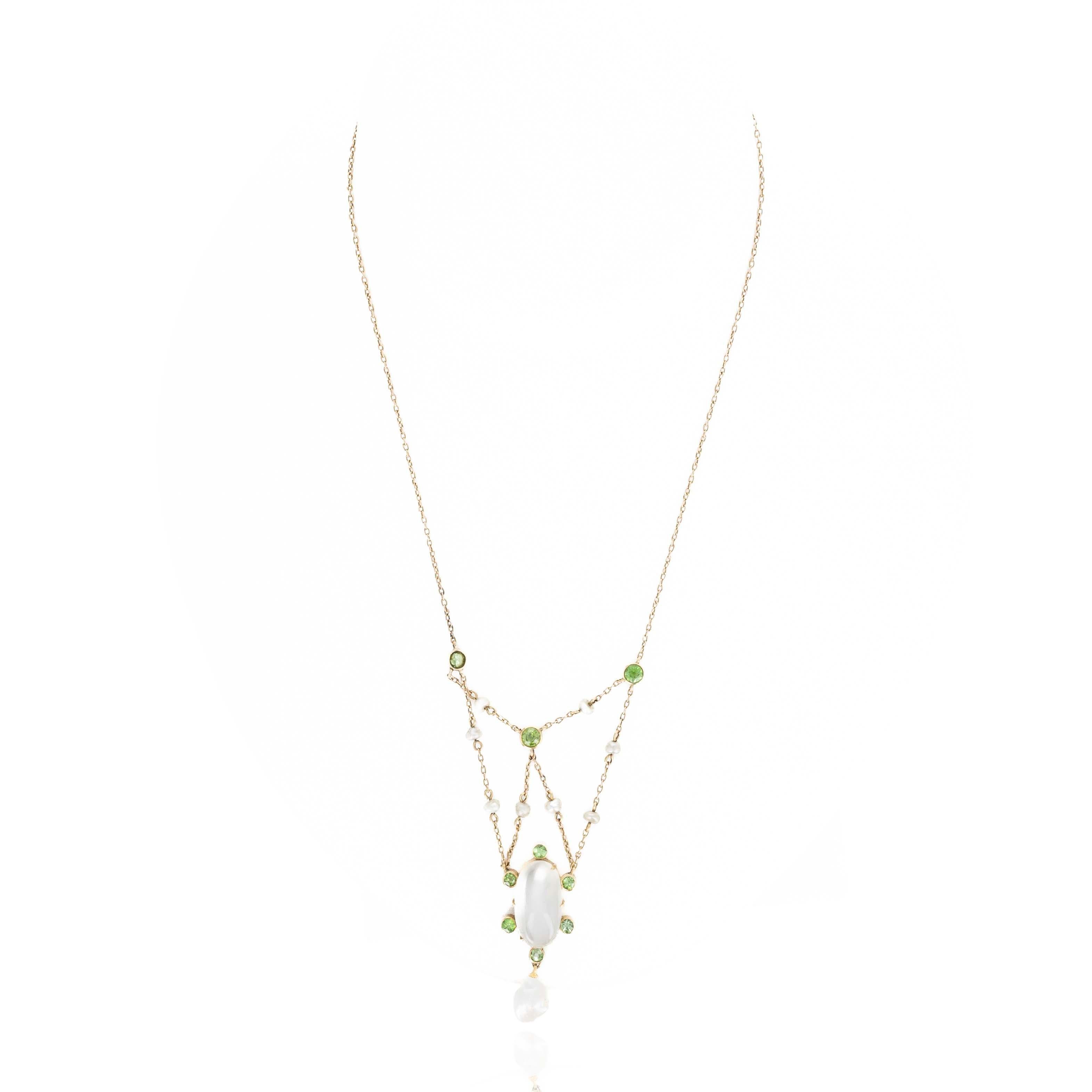 Era: Victorian Estate

Composition: 15K Yellow Gold
Primary Stone: Moonstone
Carat Weight: Approximately 5 Carats
Accent Stone: Nine Old European Cut Demantoid Garnets
Carat Weight: Approximately 1 Carats in Total
Accent Stones: Nine Natural