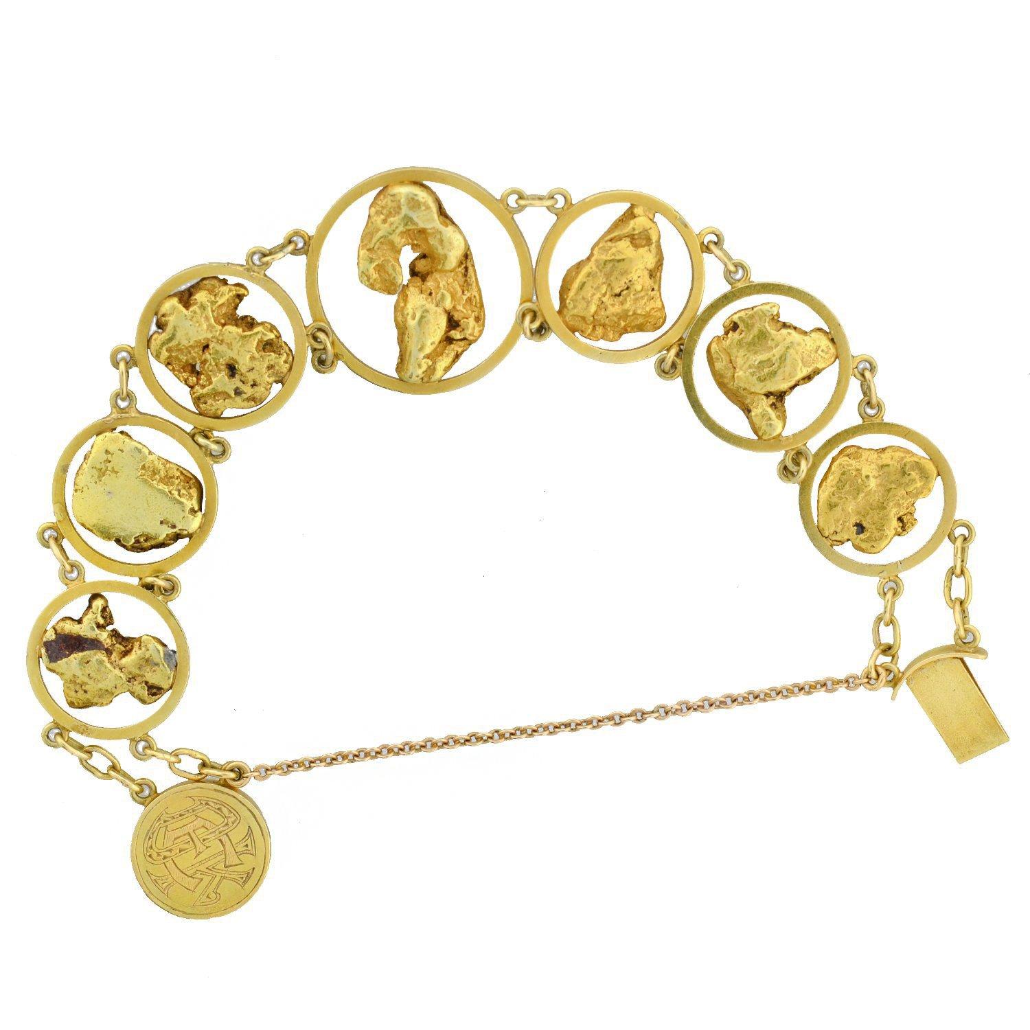 An incredible gold nugget bracelet from the Victorian (ca1880s) era! This unusual piece is crafted with 15kt yellow gold and adorns seven genuine 24kt yellow gold nuggets, which would have likely been collectable souvenirs from the Californian or