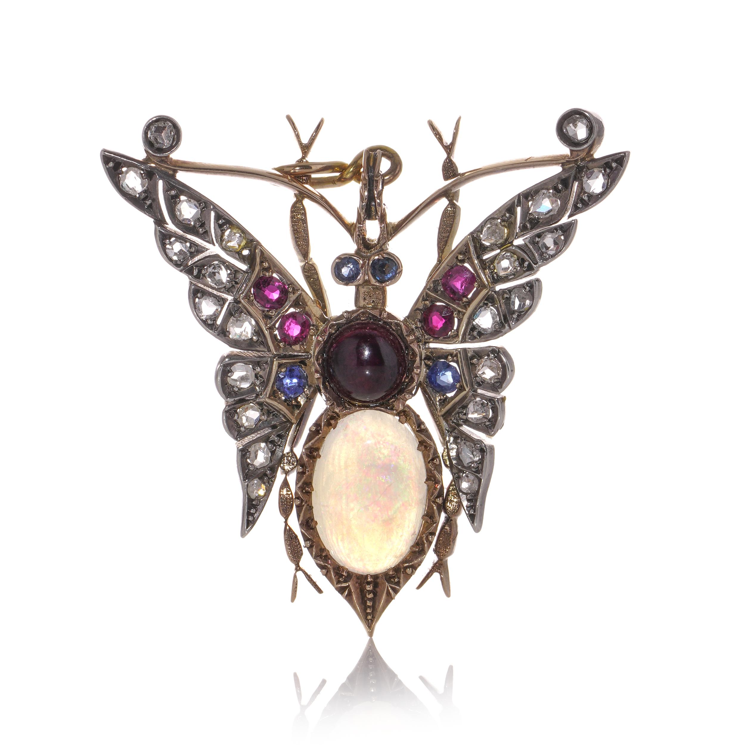 Antique Victorian 15kt gold and silver butterfly brooch with natural opal, diamonds, rubies, and sapphires.
Made in England, Circa 1880's.
X - Ray tested positive for 15kt gold and silver. 

The dimensions -
Size: 4 x 4 x 0.75 cm
Weight: 12.4