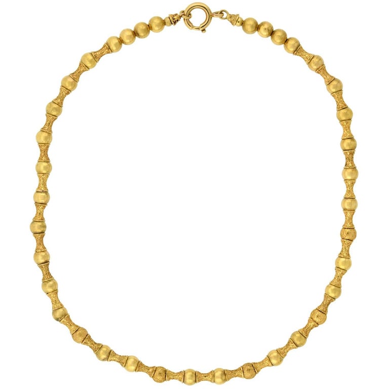 A fantastic Etruscan beaded necklace from the Victorian (ca1880s) era! This beautiful and unique piece is crafted in vibrant 15kt yellow gold and comprised of a pattern of alternating beads. The beads, all strung on a braided gold chain, display a