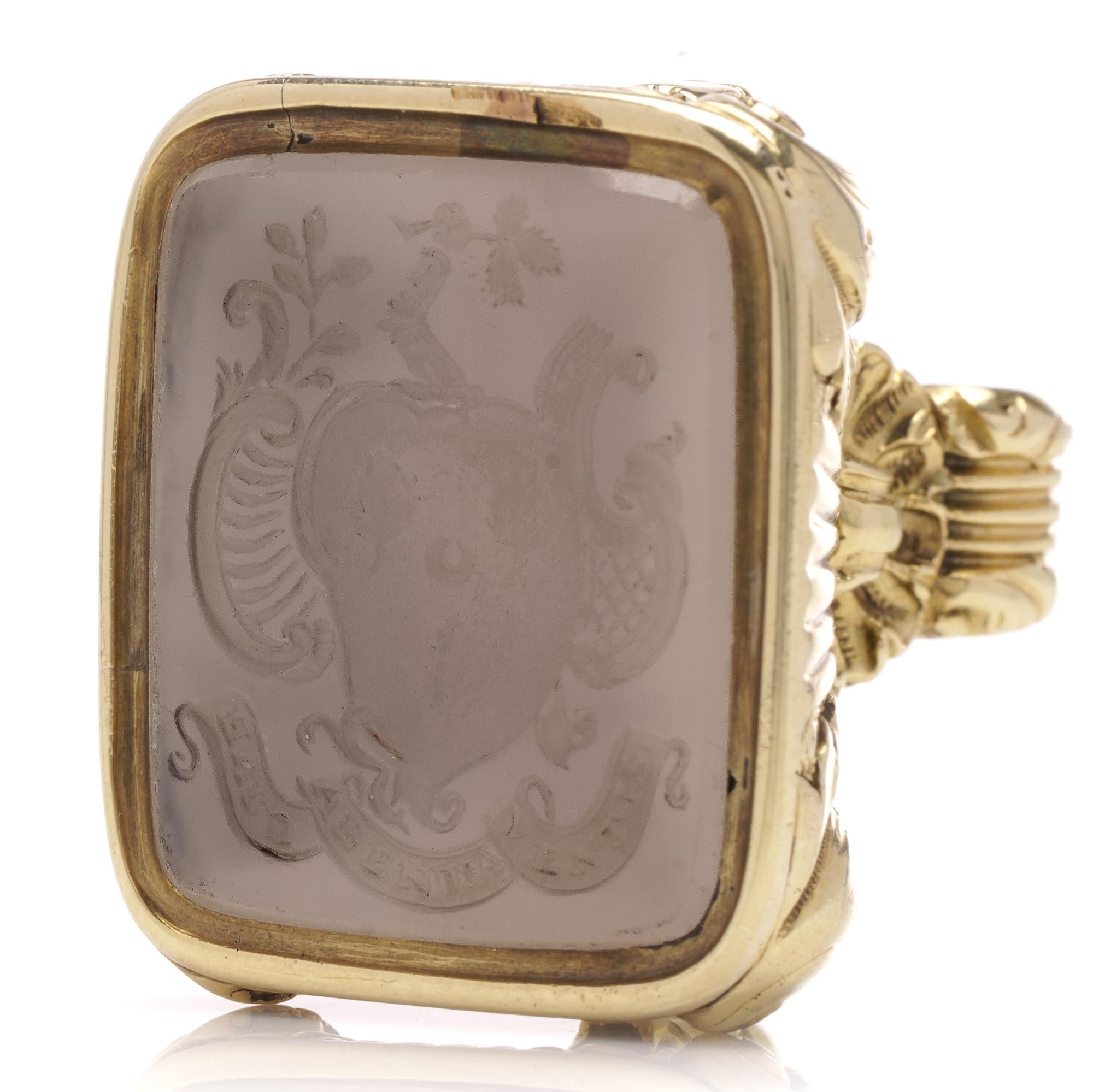 This exquisite 19th-century 15kt yellow gold seal fob/pendant, The seal features a sardonyx intaglio set in a 15kt yellow gold mount, showcasing a carved stone depicting Irving surname coat of arms with a family motto: ' Haud labentia ventis