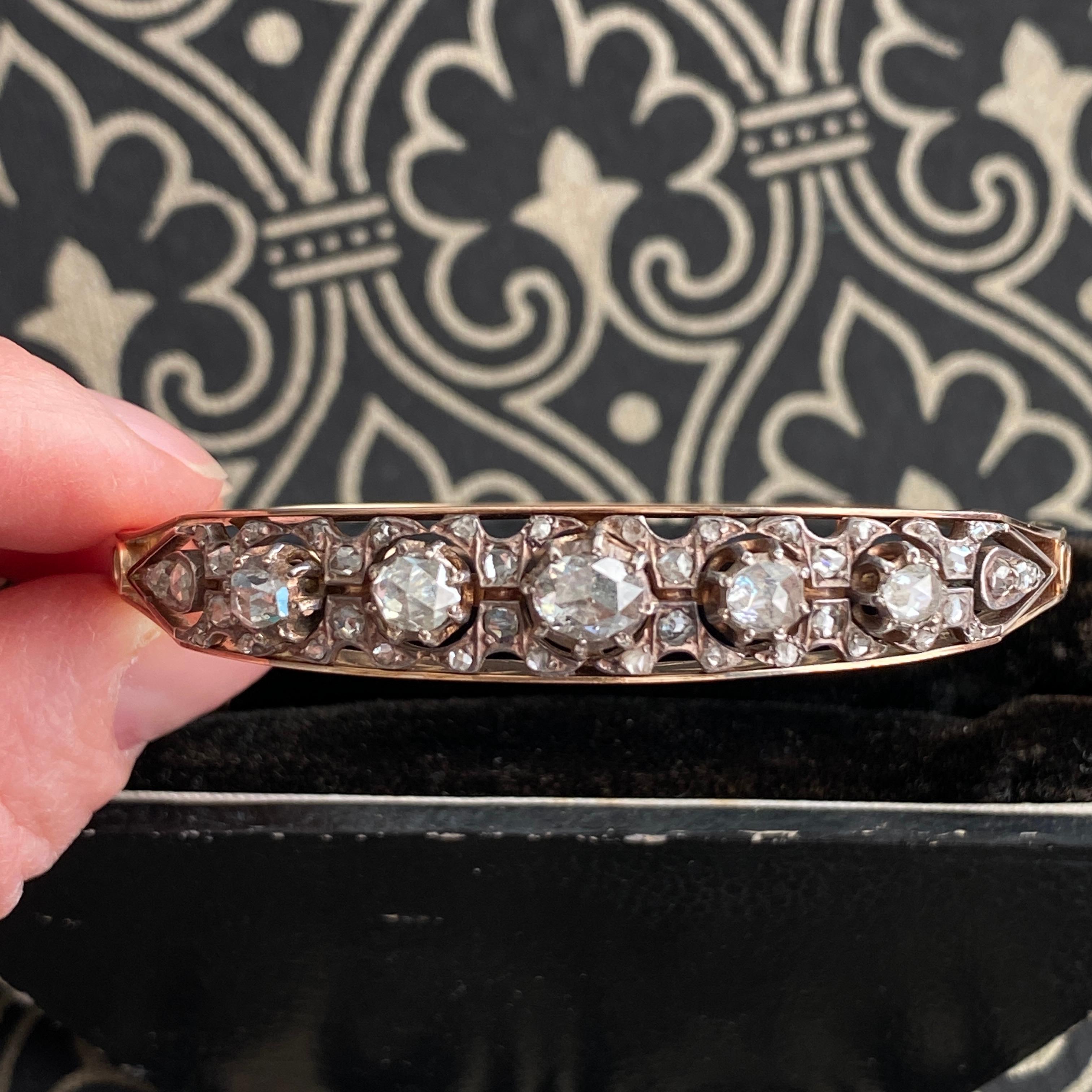 Details:
Beautiful antique rose cut diamond bangle bracelet in 18K rose gold. Set across the top, in cast mountings emulating the Georgian Style are five rose cut diamonds, weighing approximately 1.26 carats combined total weight with G-H-I color