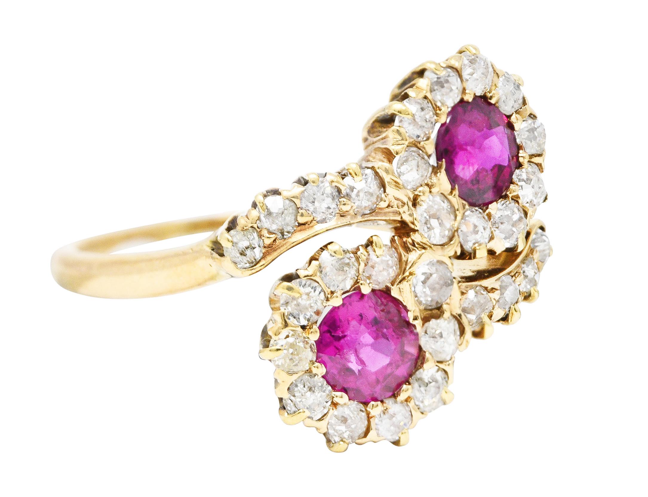 Designed as a bypass ring terminating with round cut rubies weighing approximately 1.10 carats total. Transparent purplish red in color - accented by old European cut diamond surround. Weighing approximately 0.66 carat total - H/I color with SI