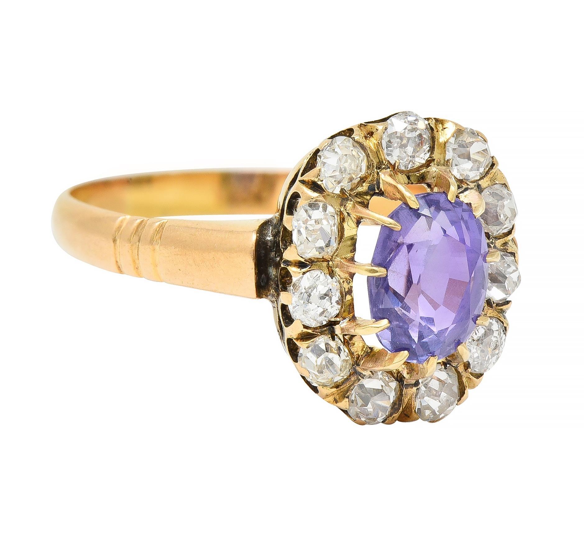 Centering an oval cut sapphire weighing 1.12 carats - transparent light purple in color 
Natural Sri Lankan in origin with no indications of heat treatment 
Prong set with a recessed halo surround of old mine cut diamonds
Weighing approximately 0.66