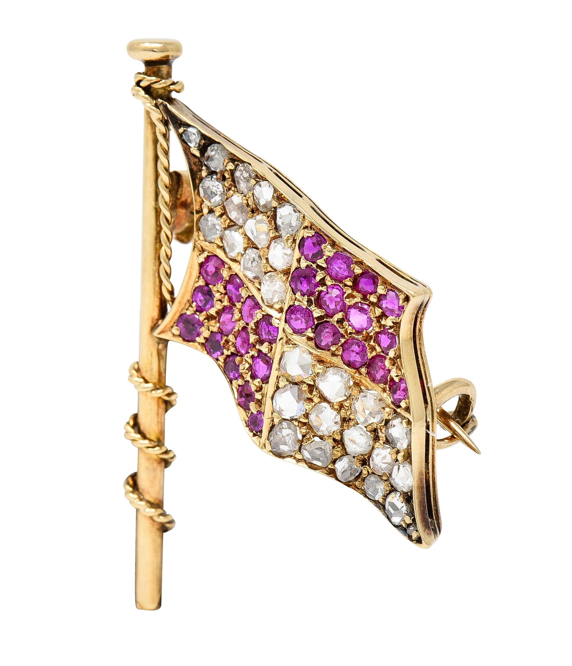 Designed as a flag hoisted on rope-wrapped flagpole and billowing
Featuring a checkered pattern comprised of rubies and diamonds
Rubies are round cut and weigh approximately 1.12 carats total 
Transparent medium purplish-red in color - bead