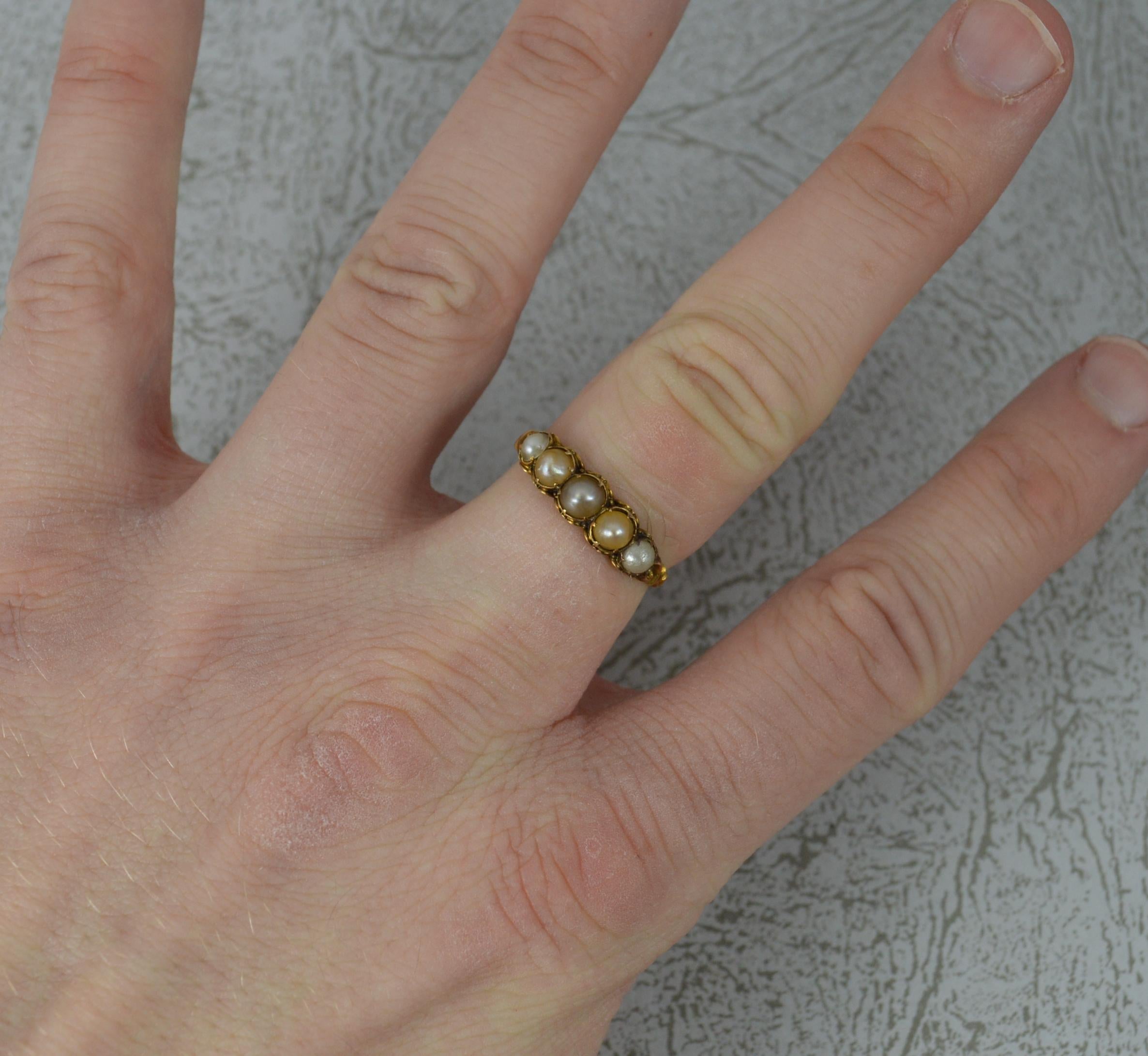 An early Victorian five stone stack ring. c1850.
Solid 18 carat yellow gold example.
Set with five pearls. 17mm spread of stones. 5.2mm wide band to front.
Size O UK, 7 1/2 US. 1.8 grams. 
Very good overall condition, light wear, tests as 18ct.